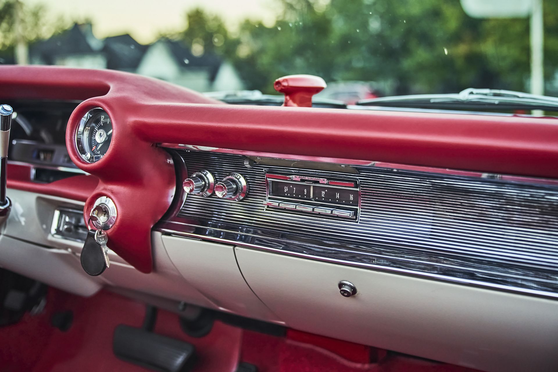 A close up of the dashboard of a red and white car.