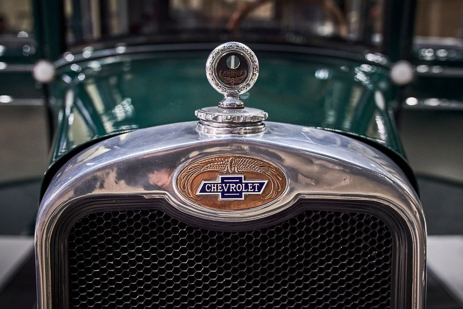 A close up of the front of an old chevrolet car