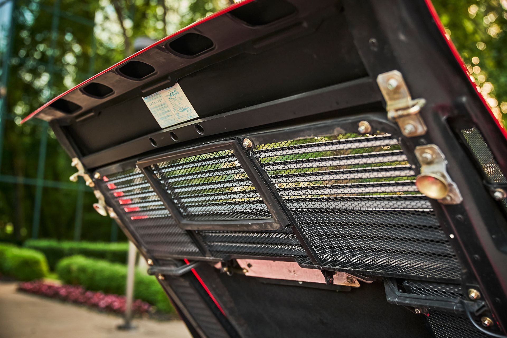 A close up of the hood of a car with the hood open.