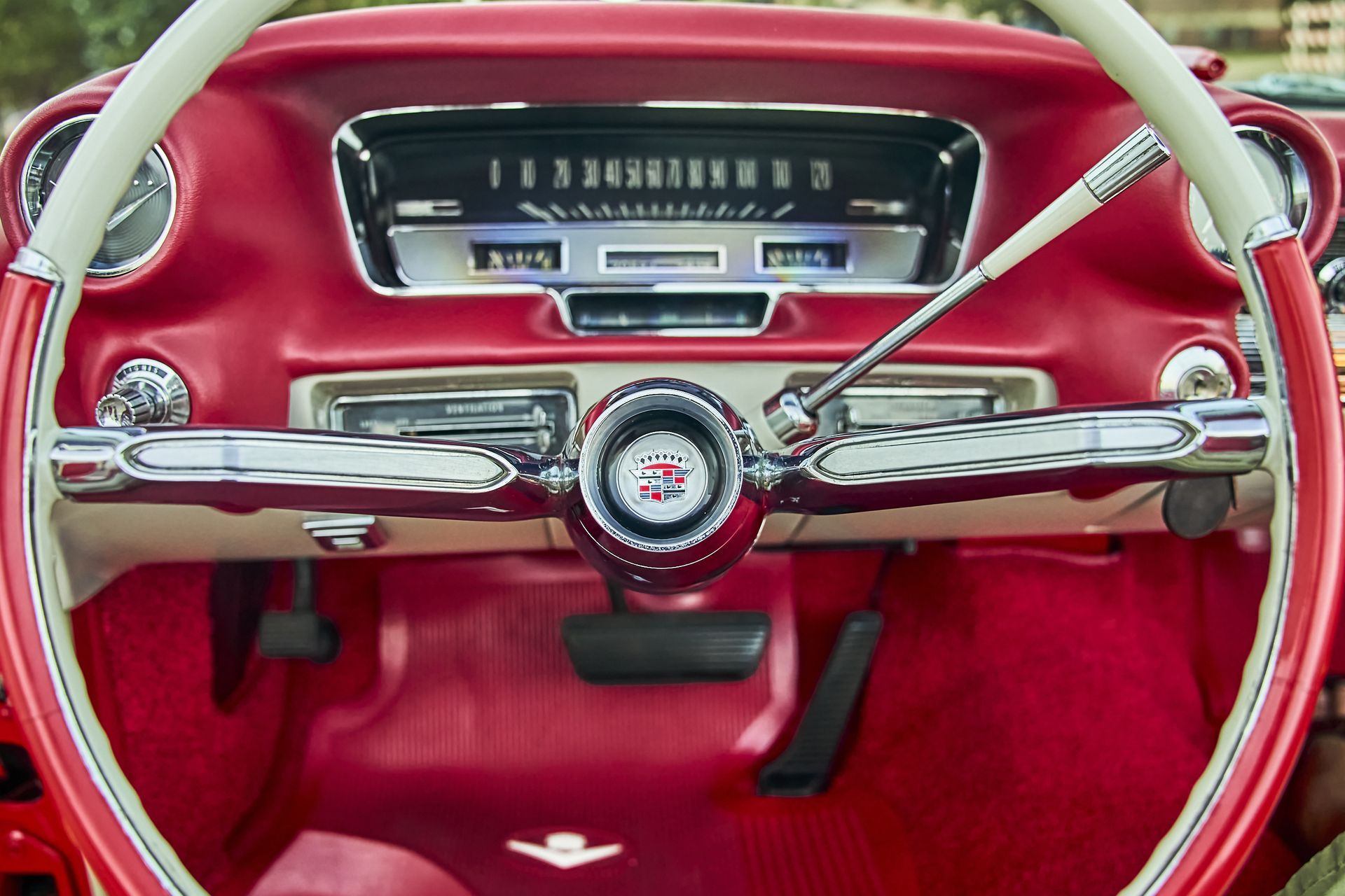 A red car with a white steering wheel and dashboard