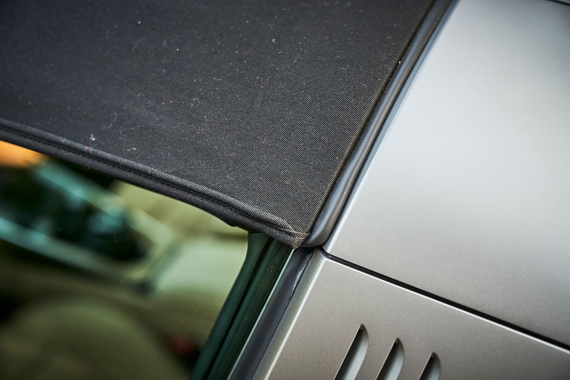 A close up of a car with a black top
