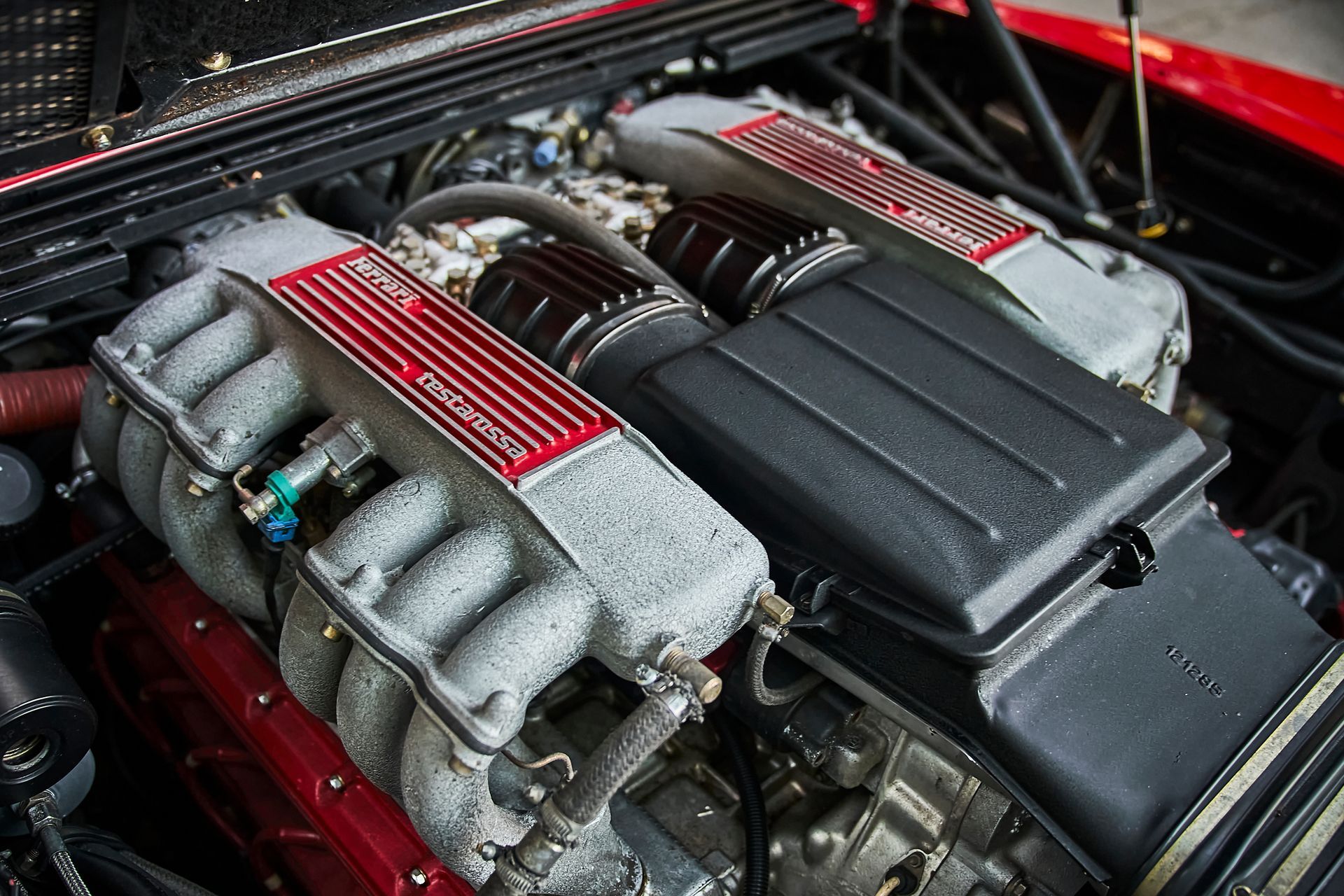 A close up of a ferrari engine in a red car