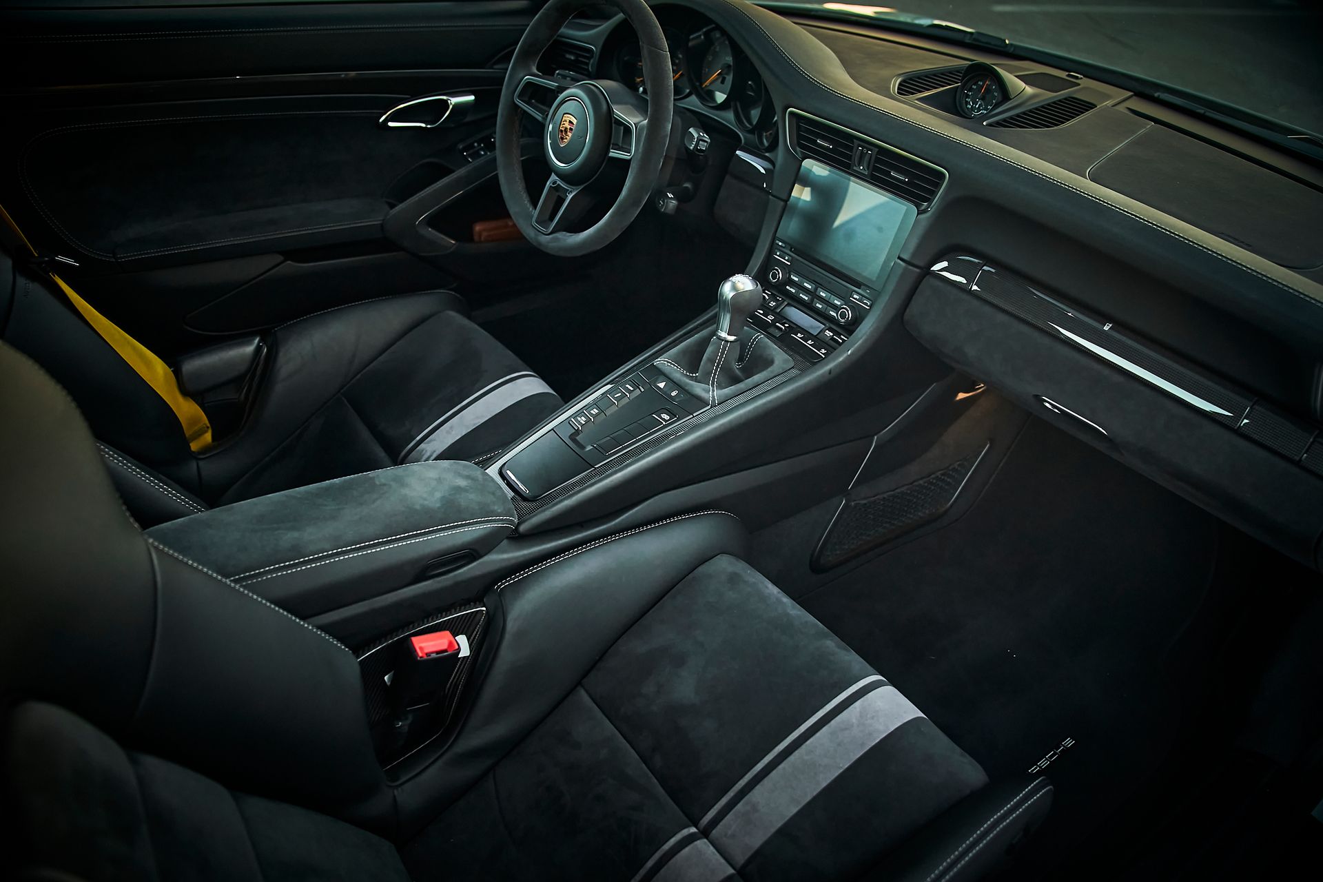 The interior of a car with black seats and a steering wheel