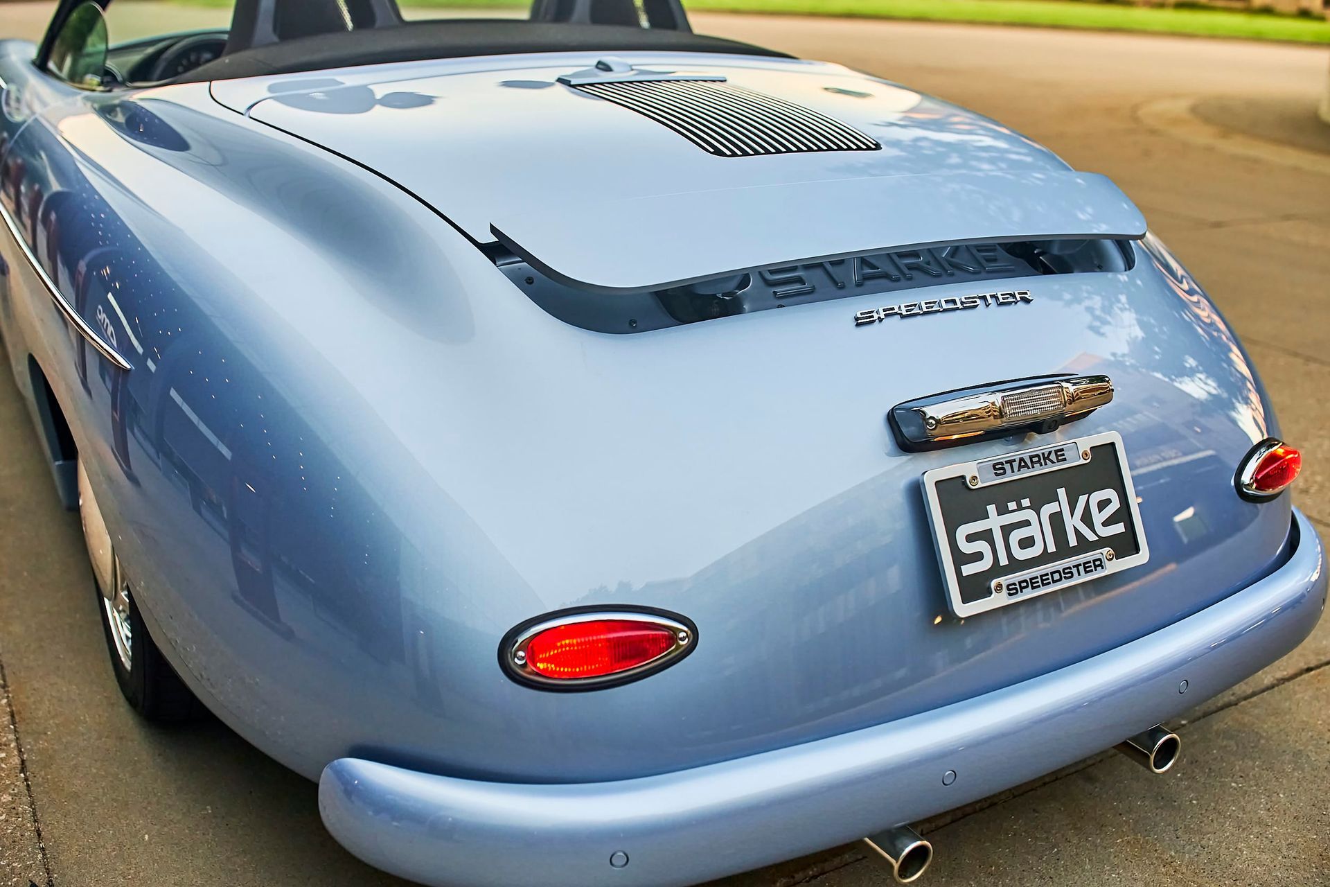 Light blue convertible car, rear view, with chrome details and the