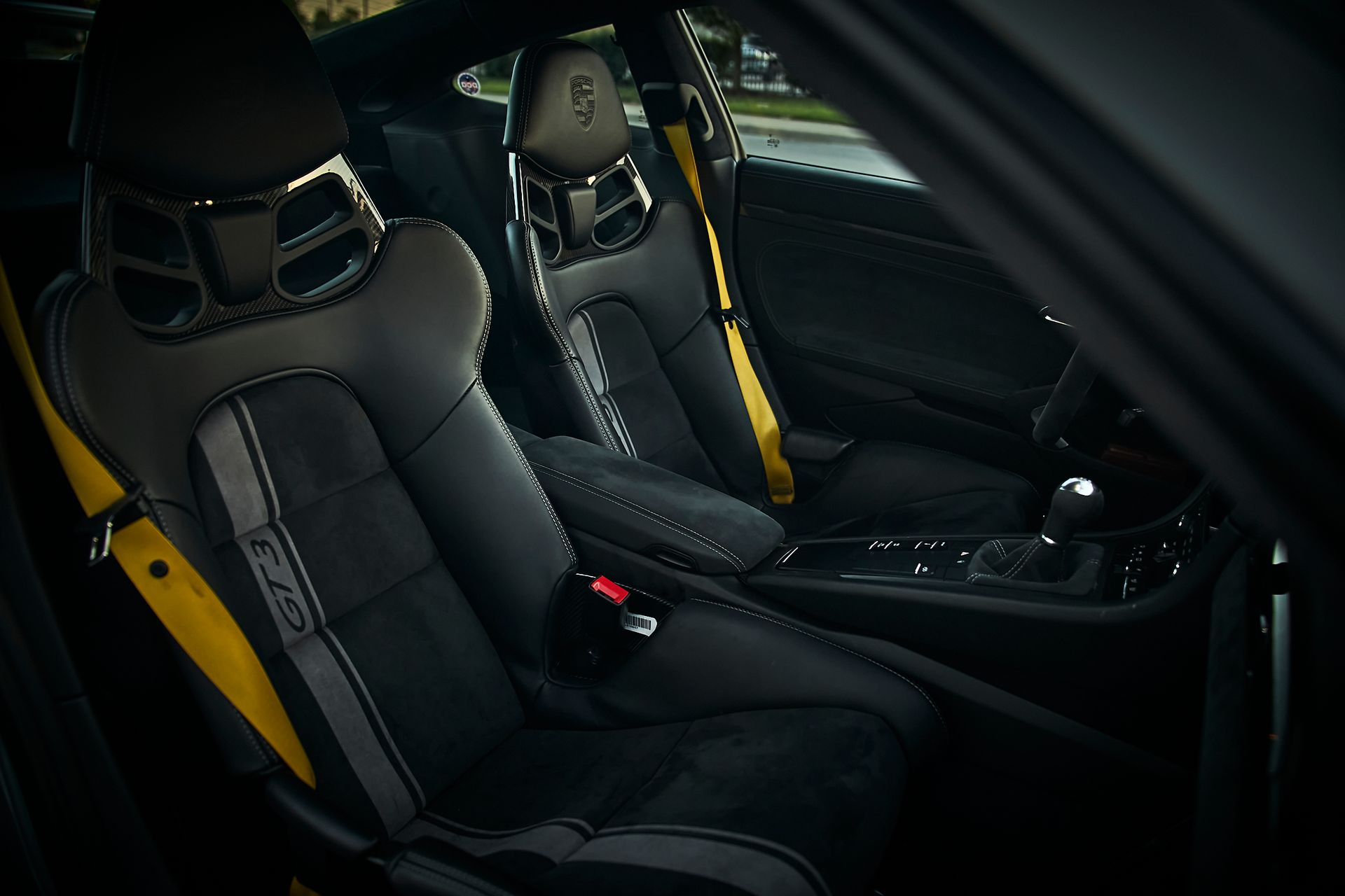 The interior of a car with black and yellow seats