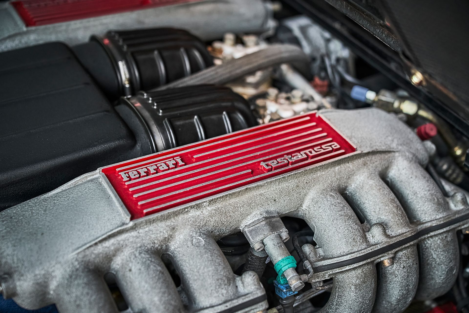 A close up of a ferrari engine in a car.