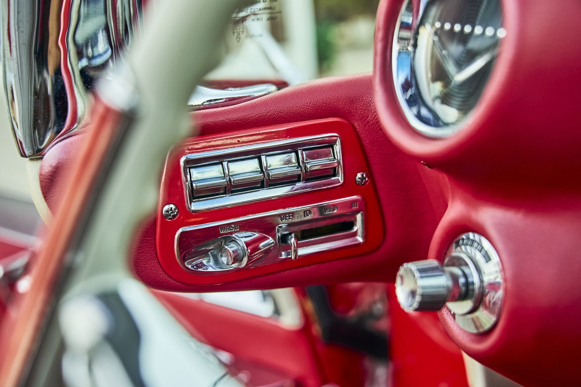 A close up of the dashboard of a red car.