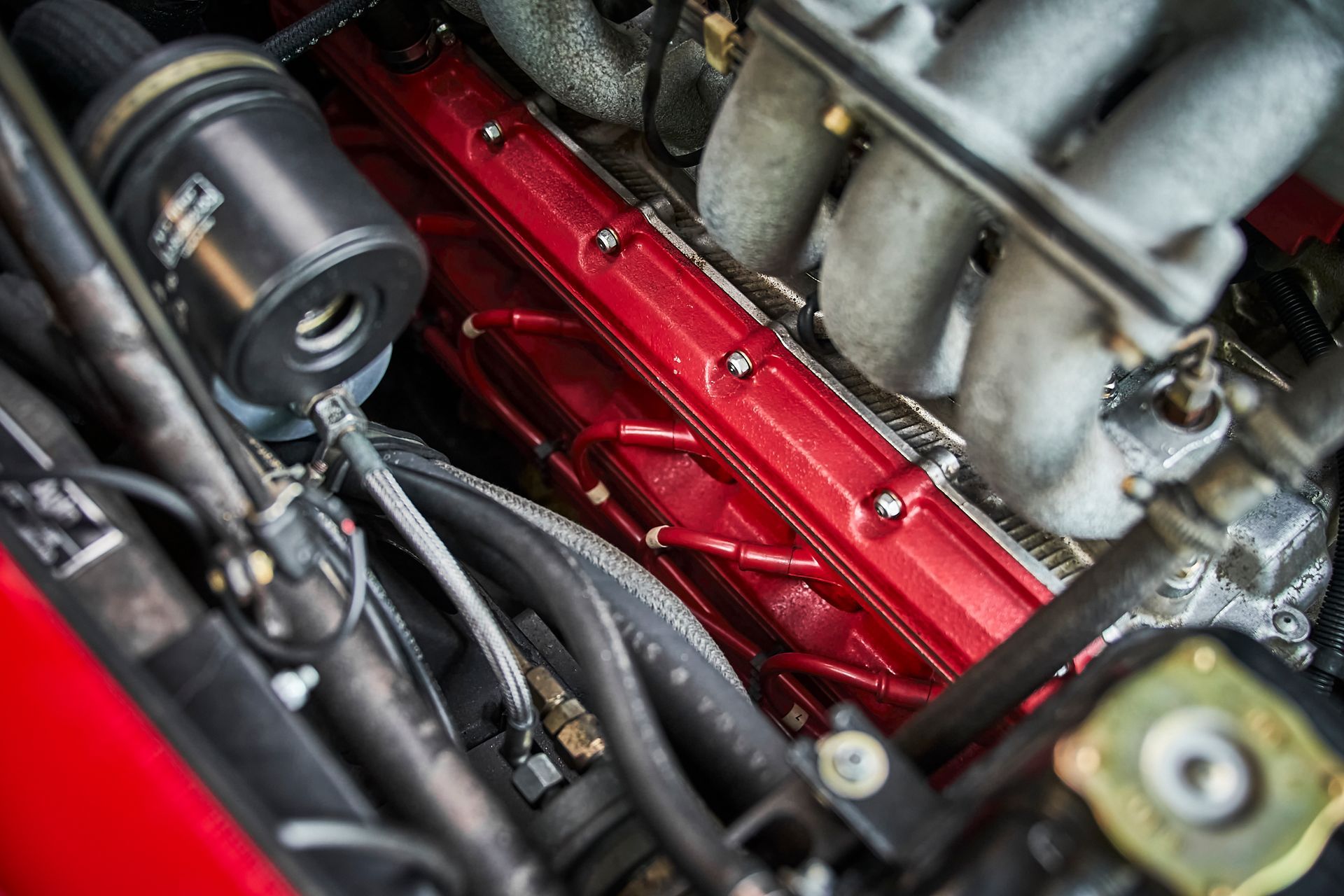 A close up of a red engine in a car.