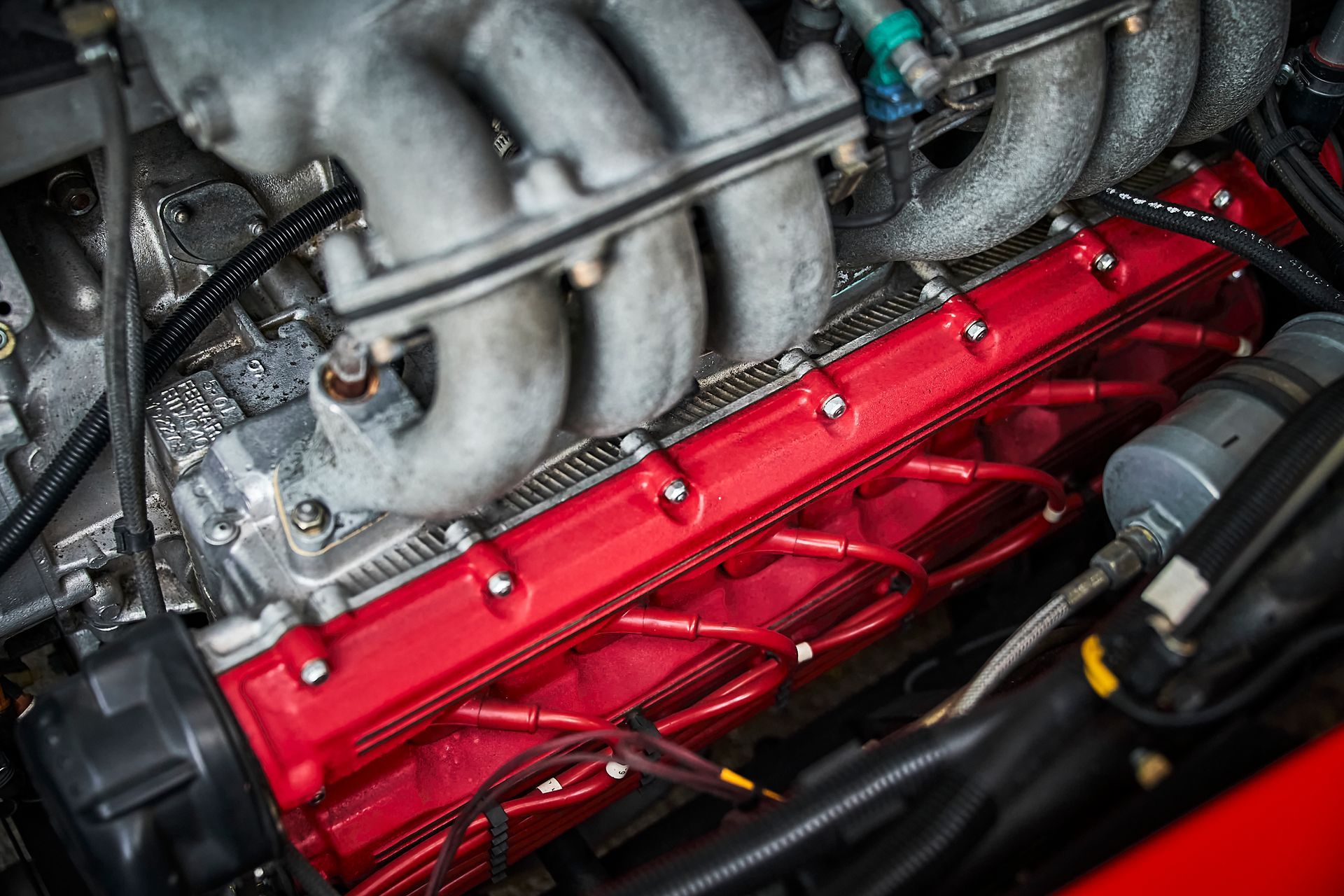 A close up of a red engine in a car.