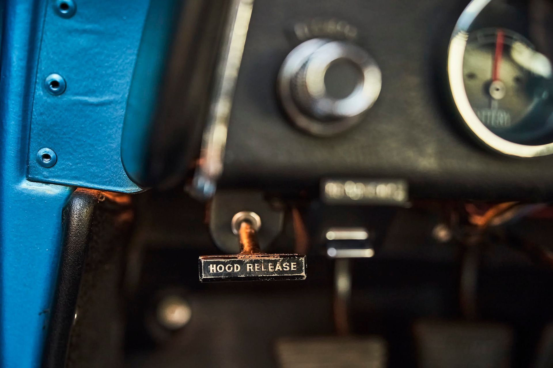 Close-up of a car's dashboard with a key in the ignition. The key fob reads 