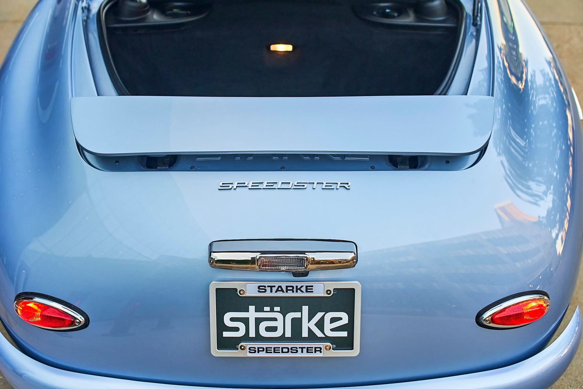 Rear view of a light blue Starke Speedster, showing the trunk, license plate, and taillights.