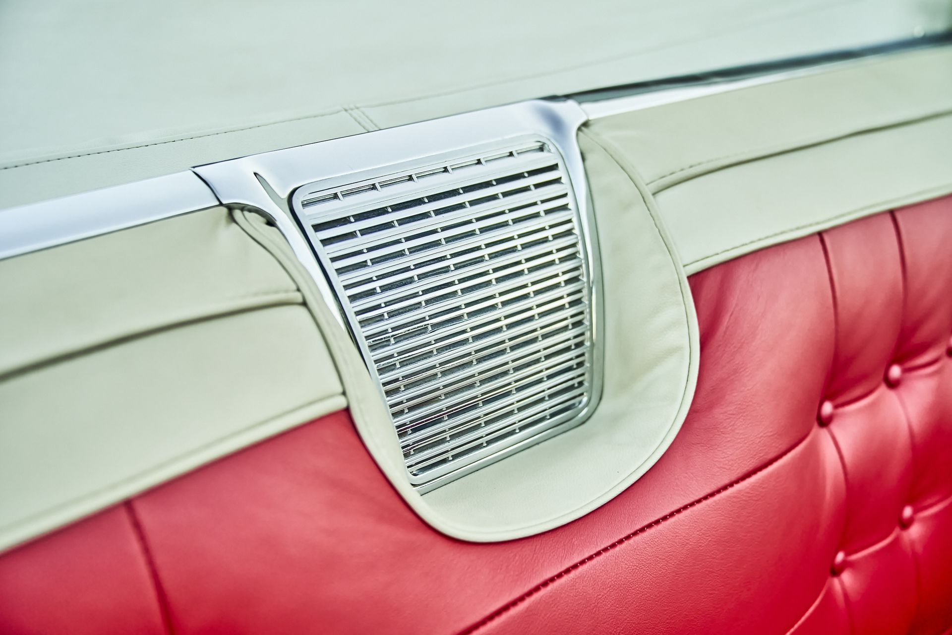 A red and white car with a speaker in the back seat.