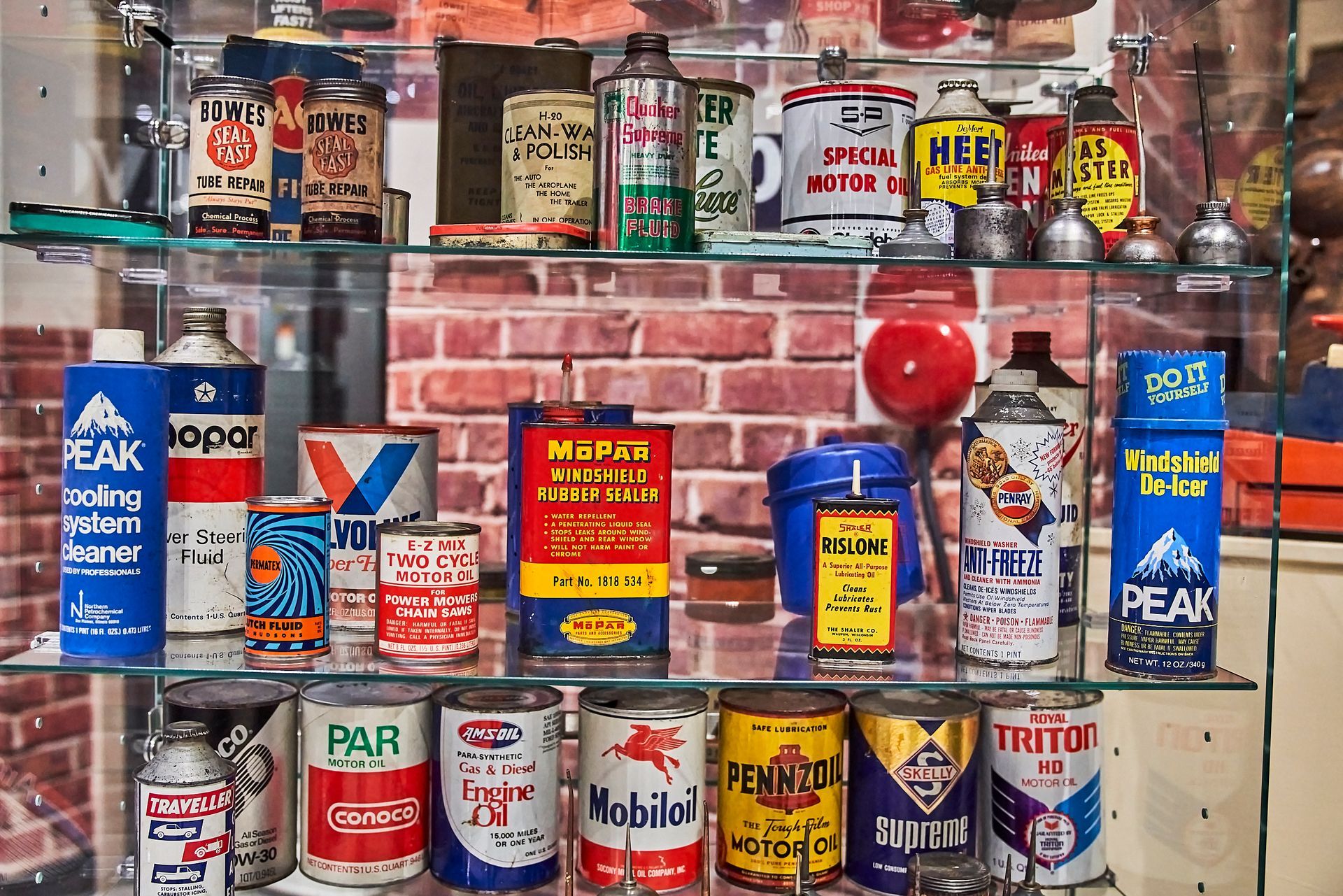 Classic Car Memorabilia -A shelf filled with a variety of cans and bottles.