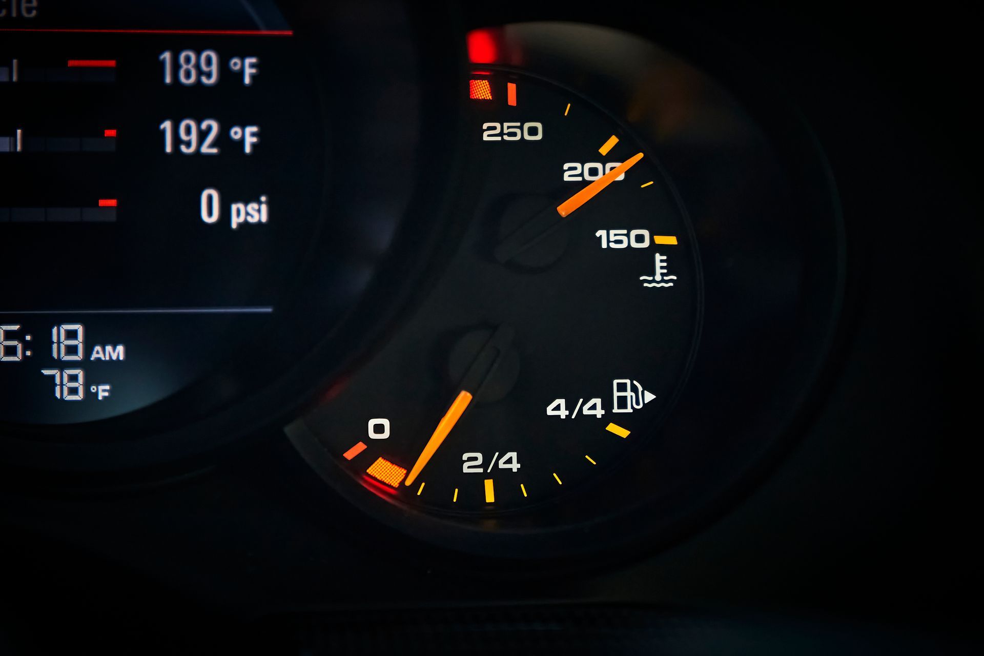 A close up of a car dashboard with a temperature gauge