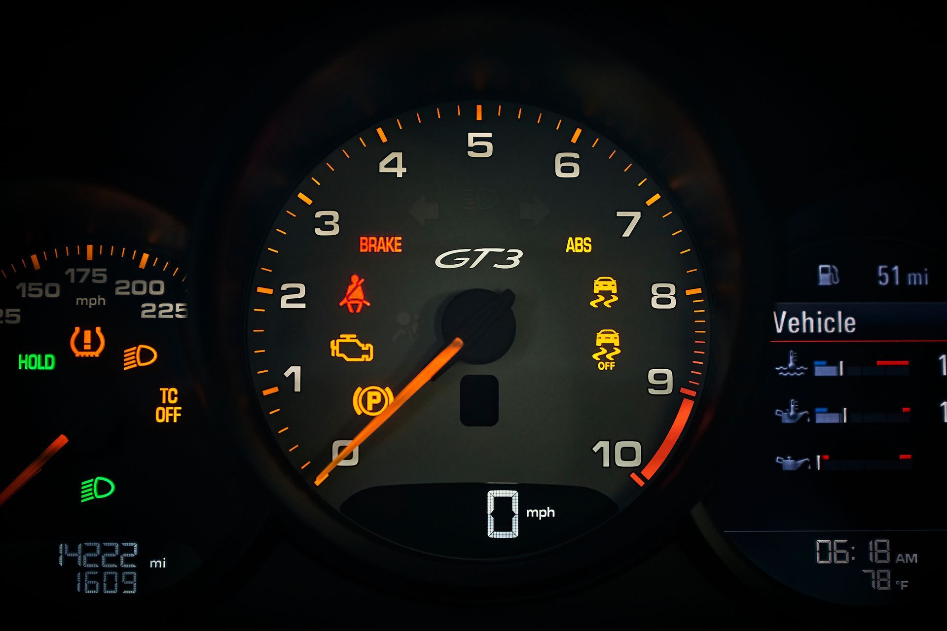 A close up of a porsche gt3 speedometer
