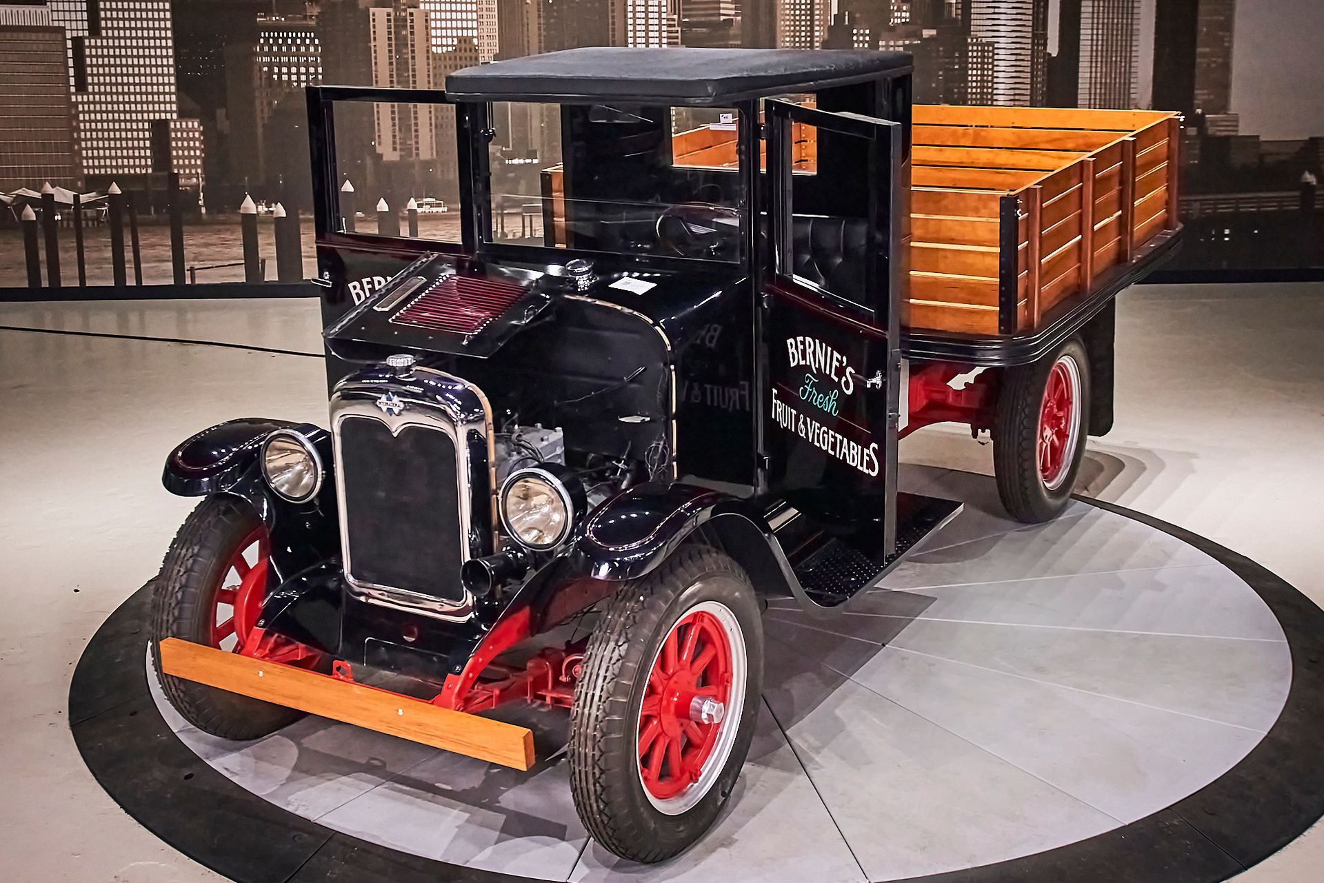 An old truck with a wooden bed is on display