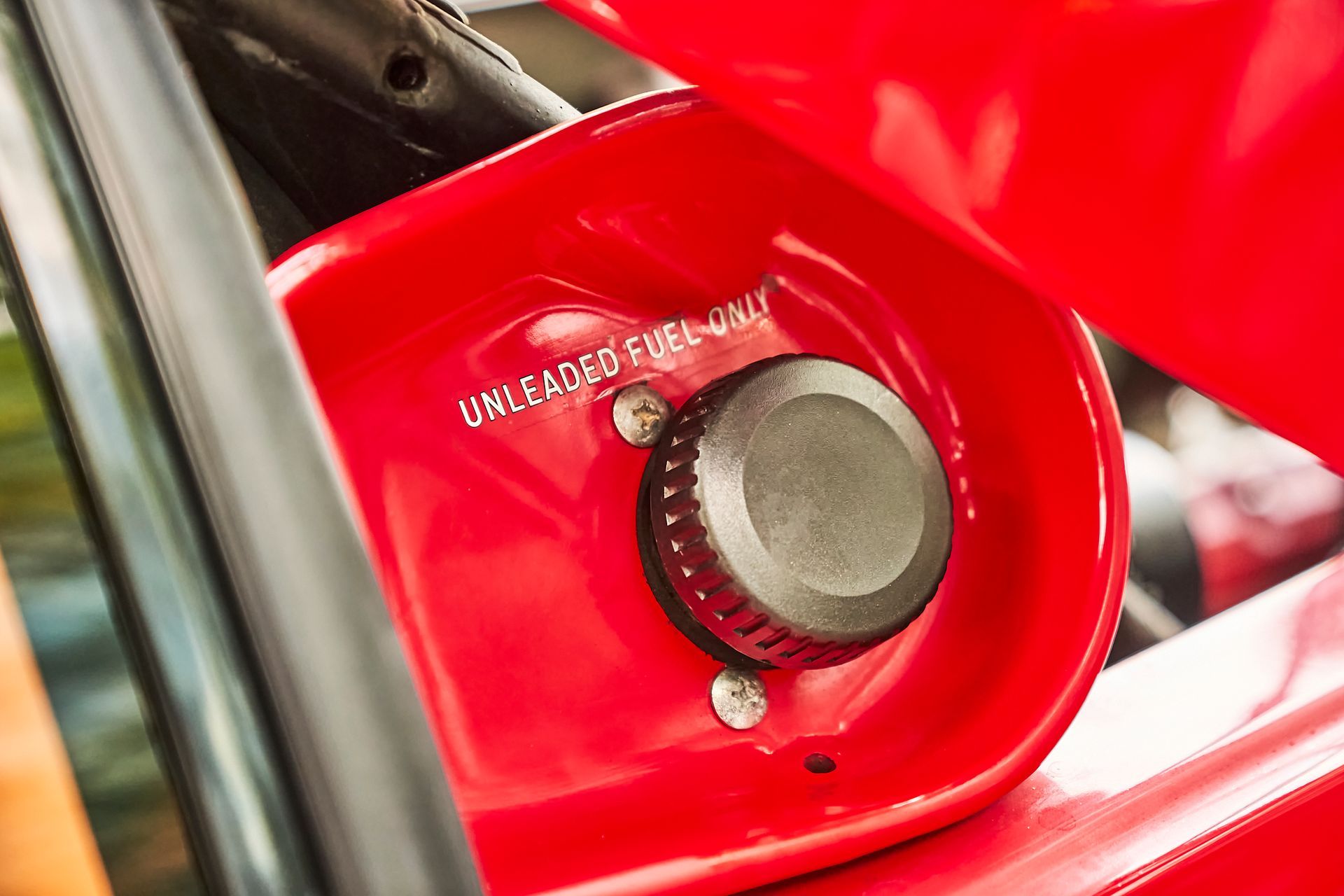 A close up of a red fuel tank on a car.