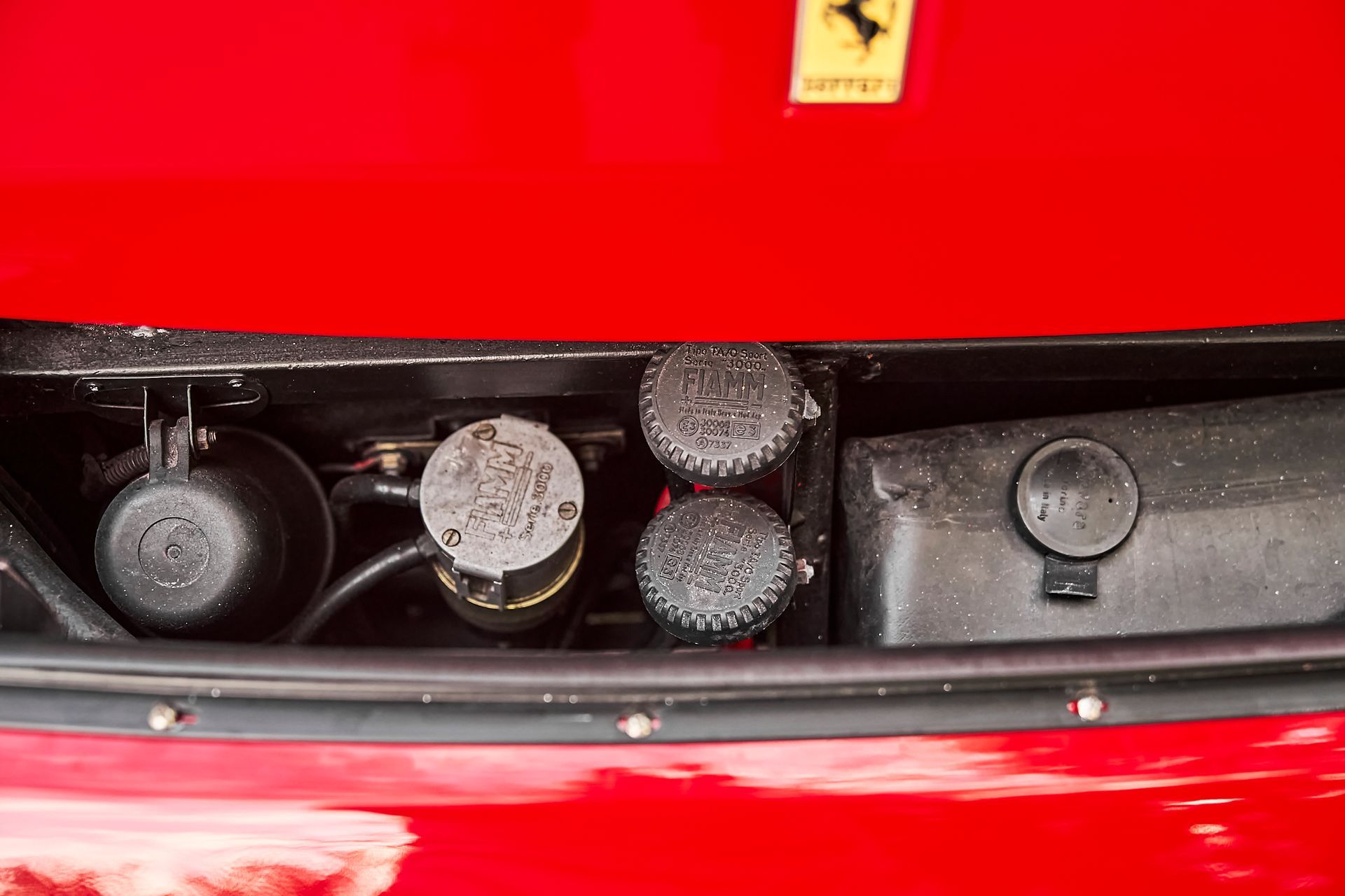 A close up of the engine of a red ferrari.