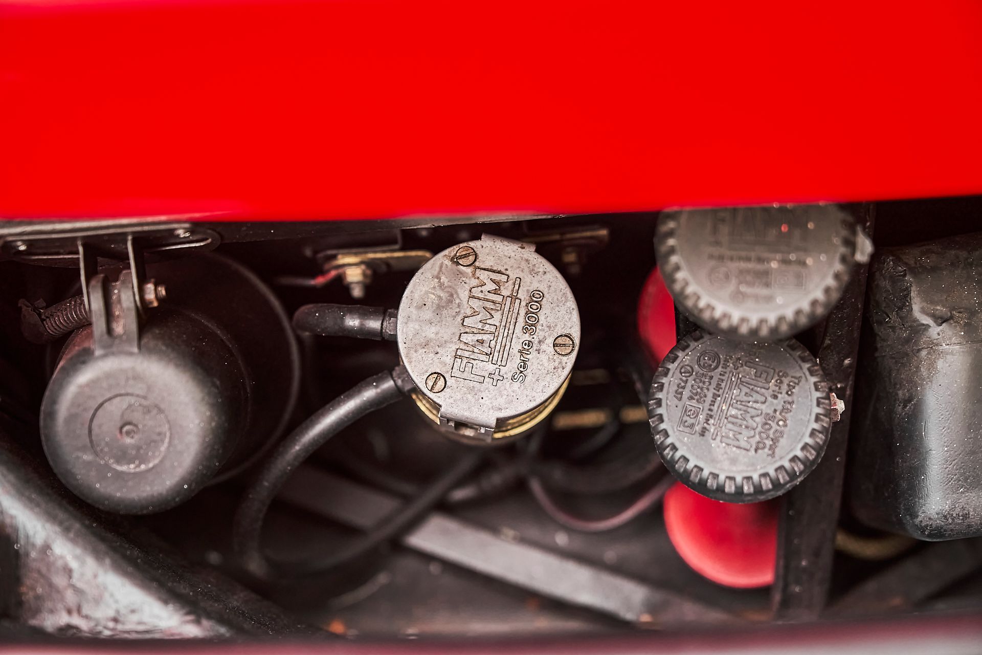 A close up of the engine of a red car.