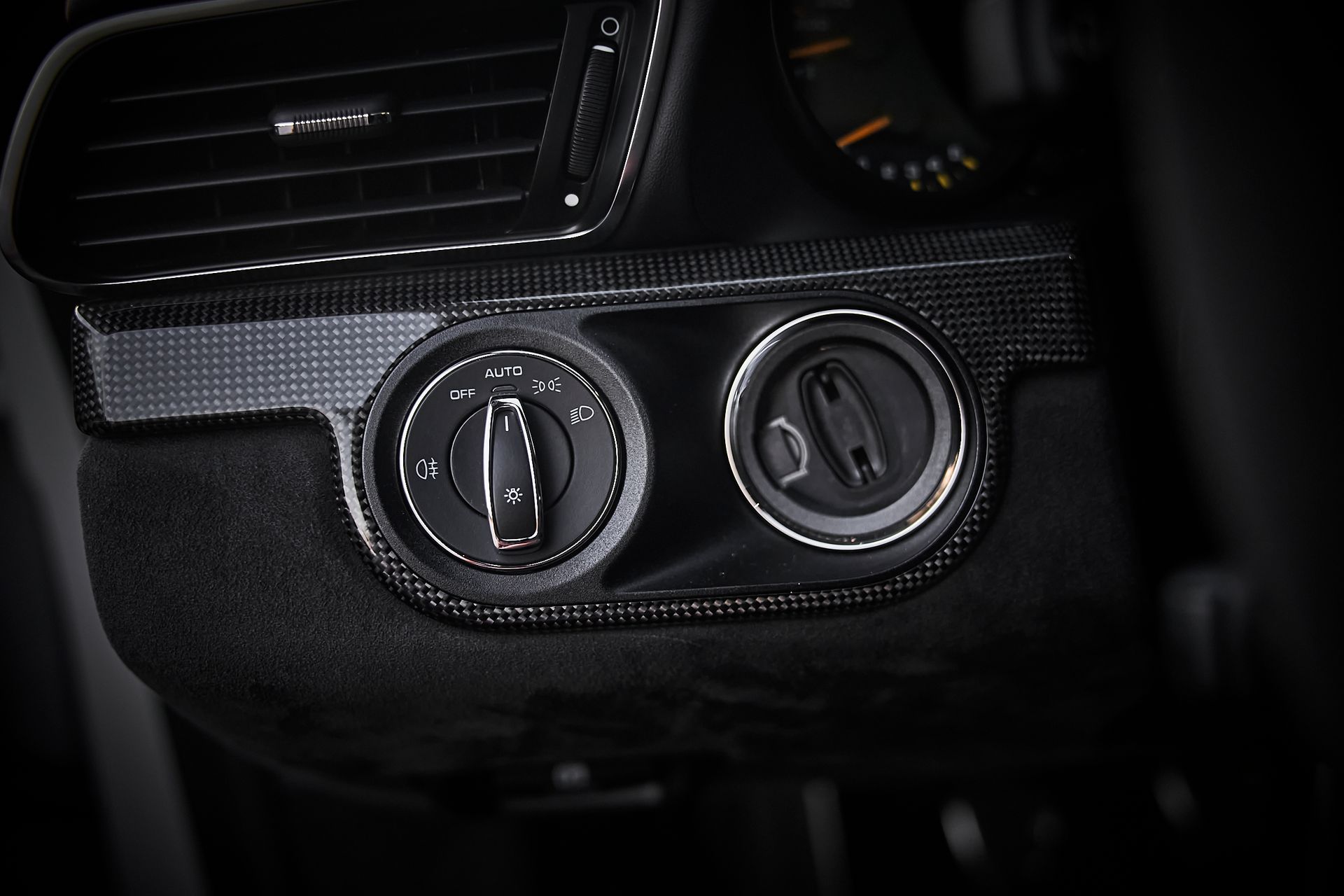A close up of a car dashboard with two buttons on it.