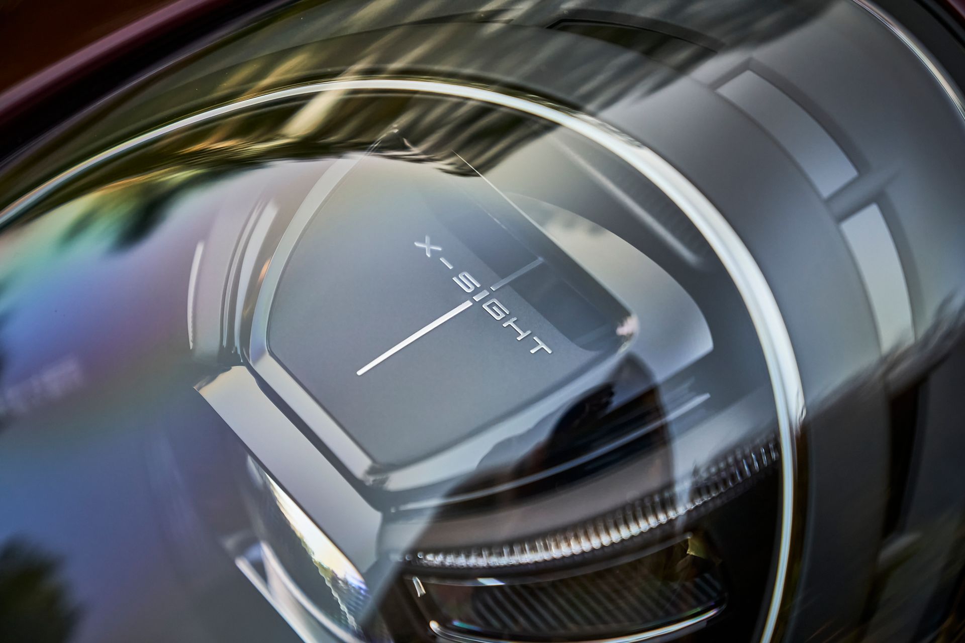 A close up of a car headlight that says x-sight