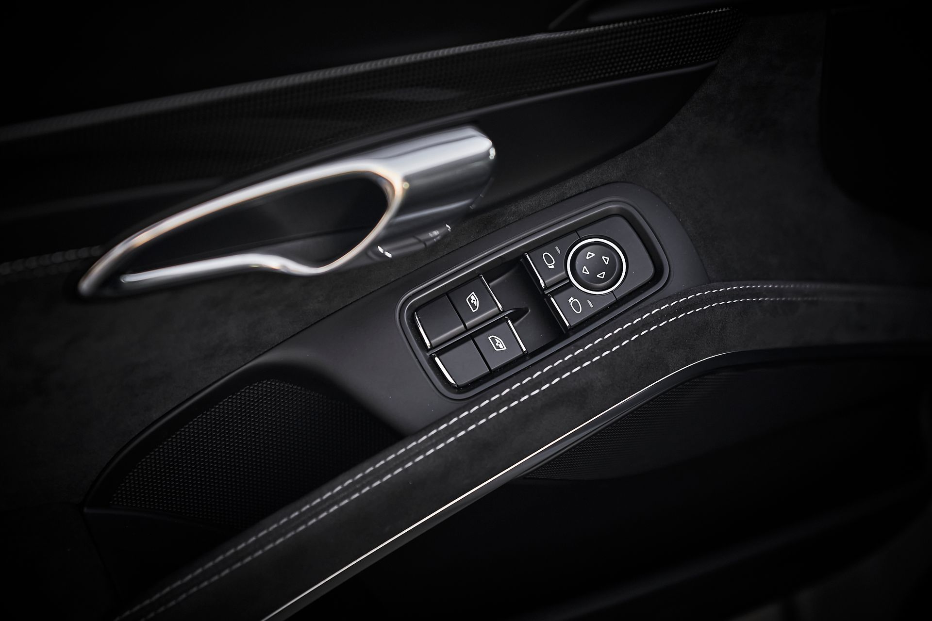 A close up of a car door control in a car.