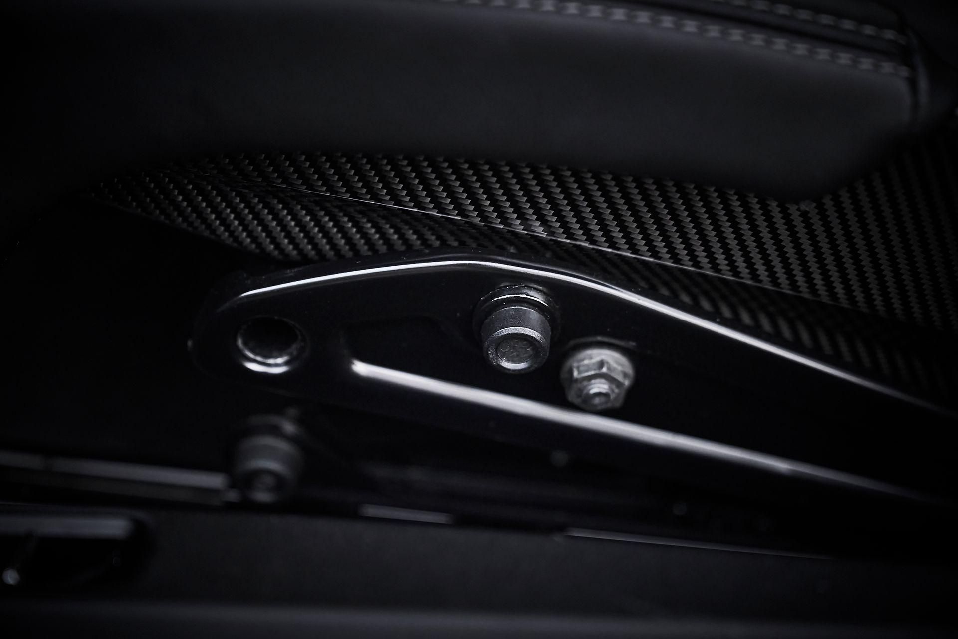 A close up of a car seat with a black background.