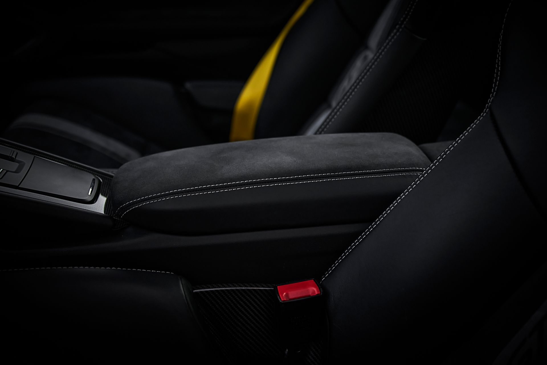 A close up of the arm rest of a car seat.