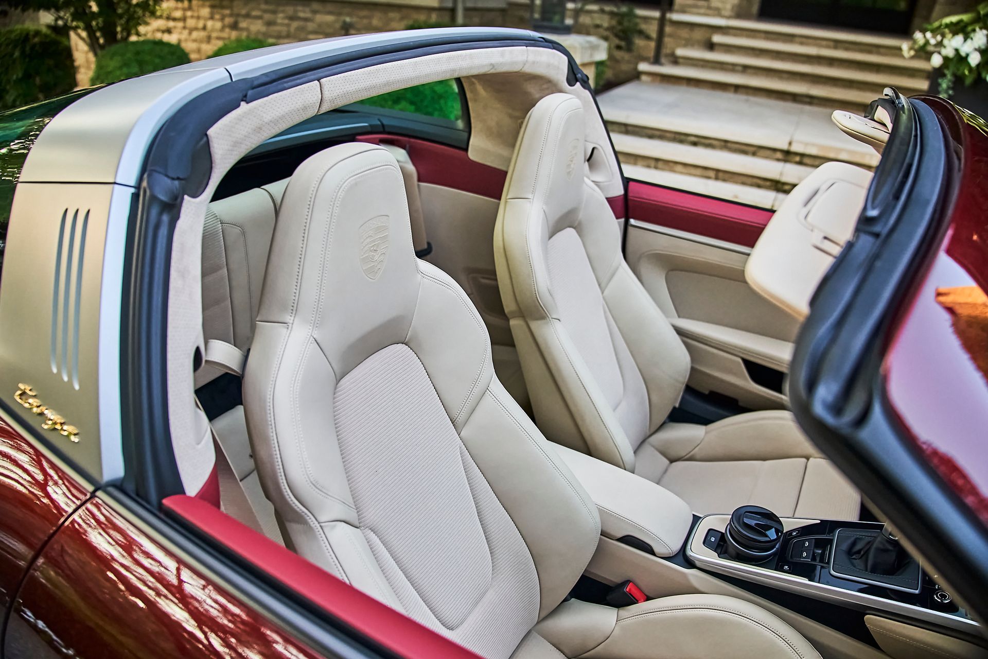 The inside of a red convertible sports car with the top down.