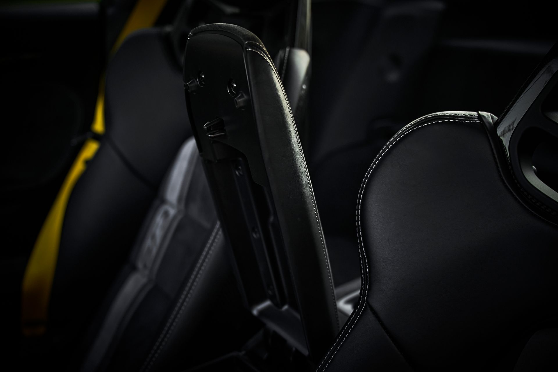 A close up of the arm rest of a car seat.