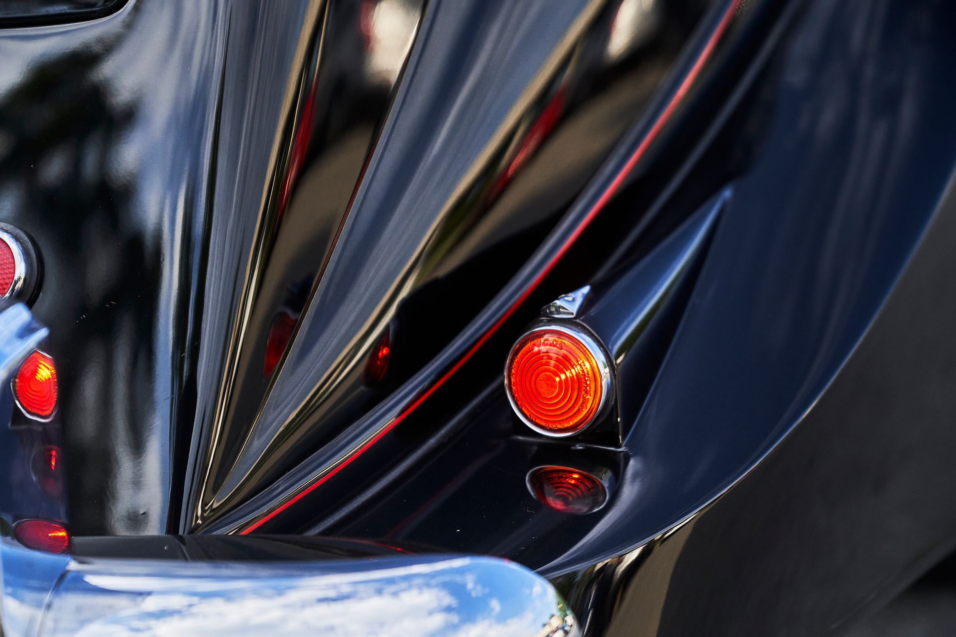A close up of a black car with red lights