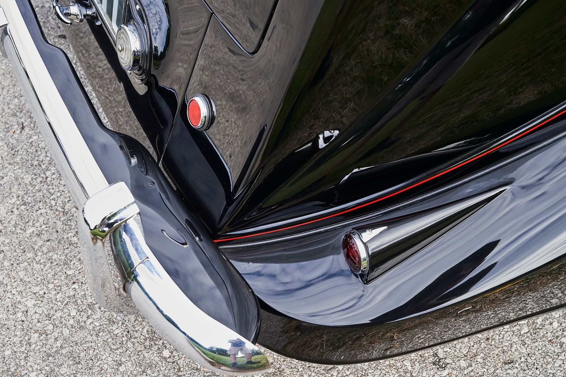 A close up of a black car with a chrome bumper