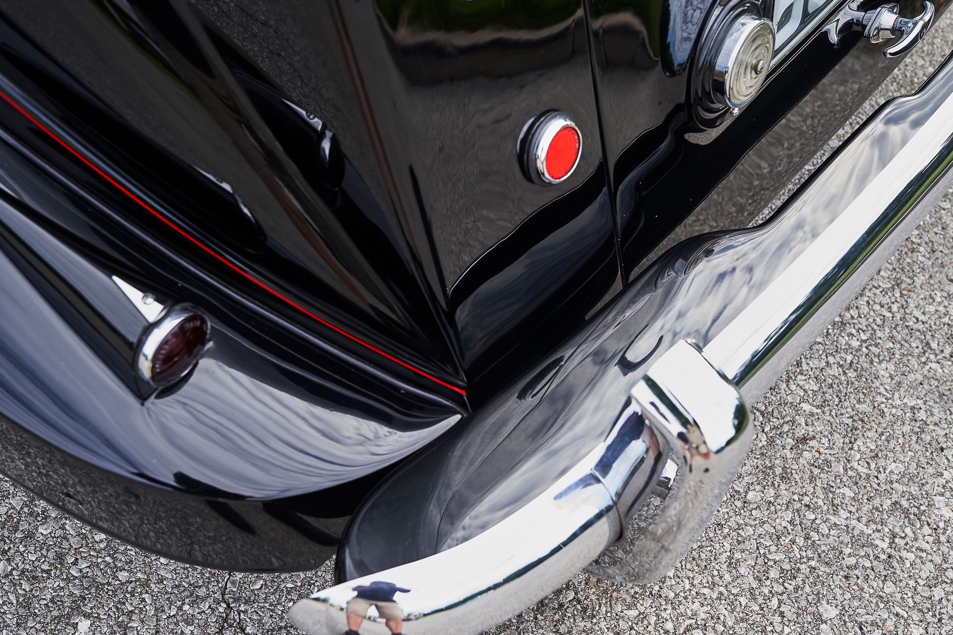 A black car with a red button on the door