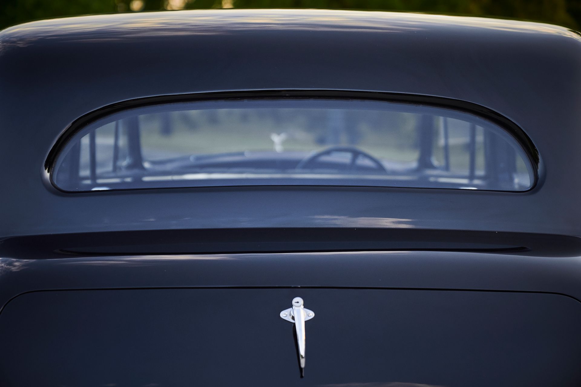 A black car with a cross on the back of it
