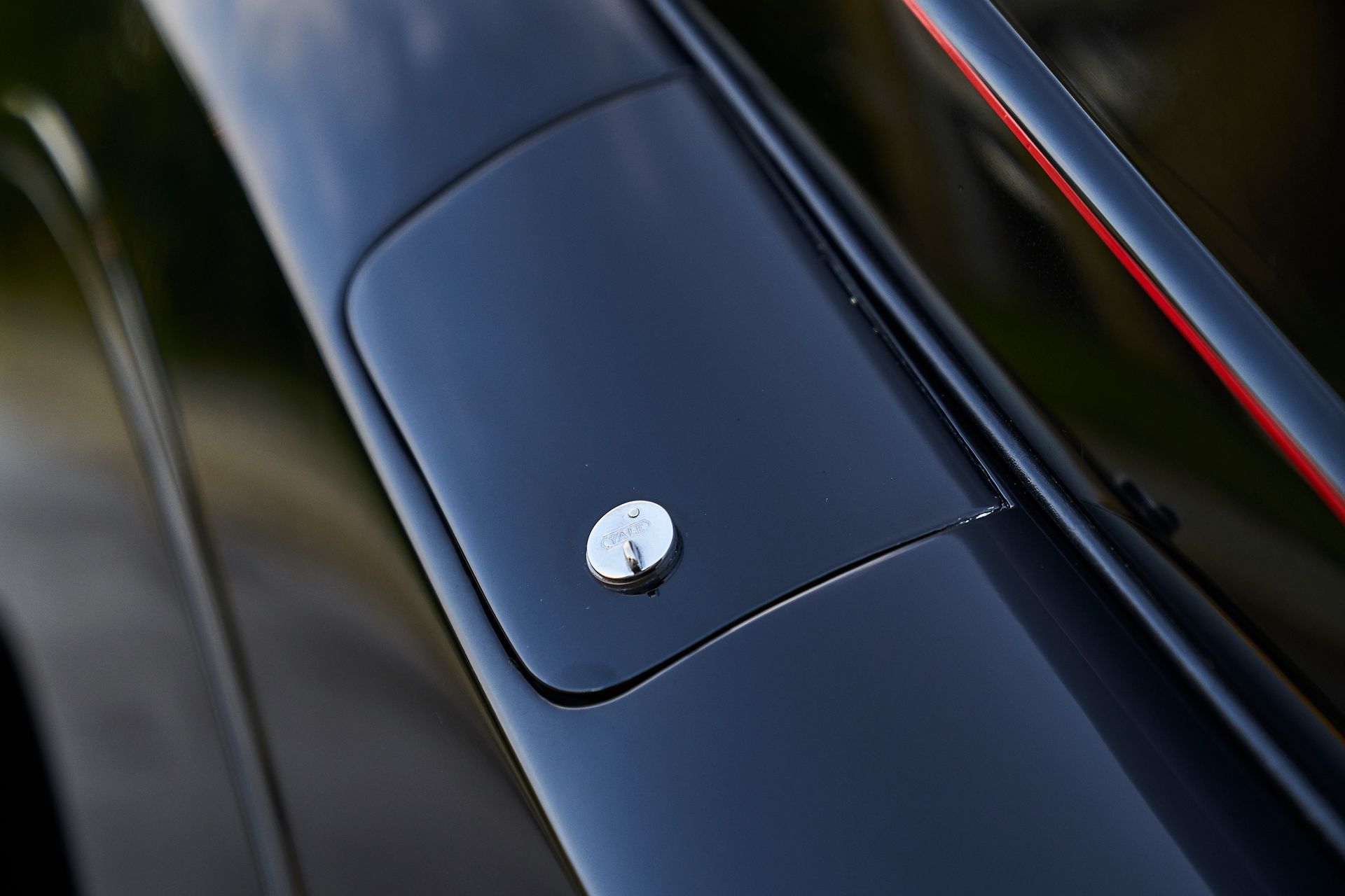 A close up of a black car with a red trim