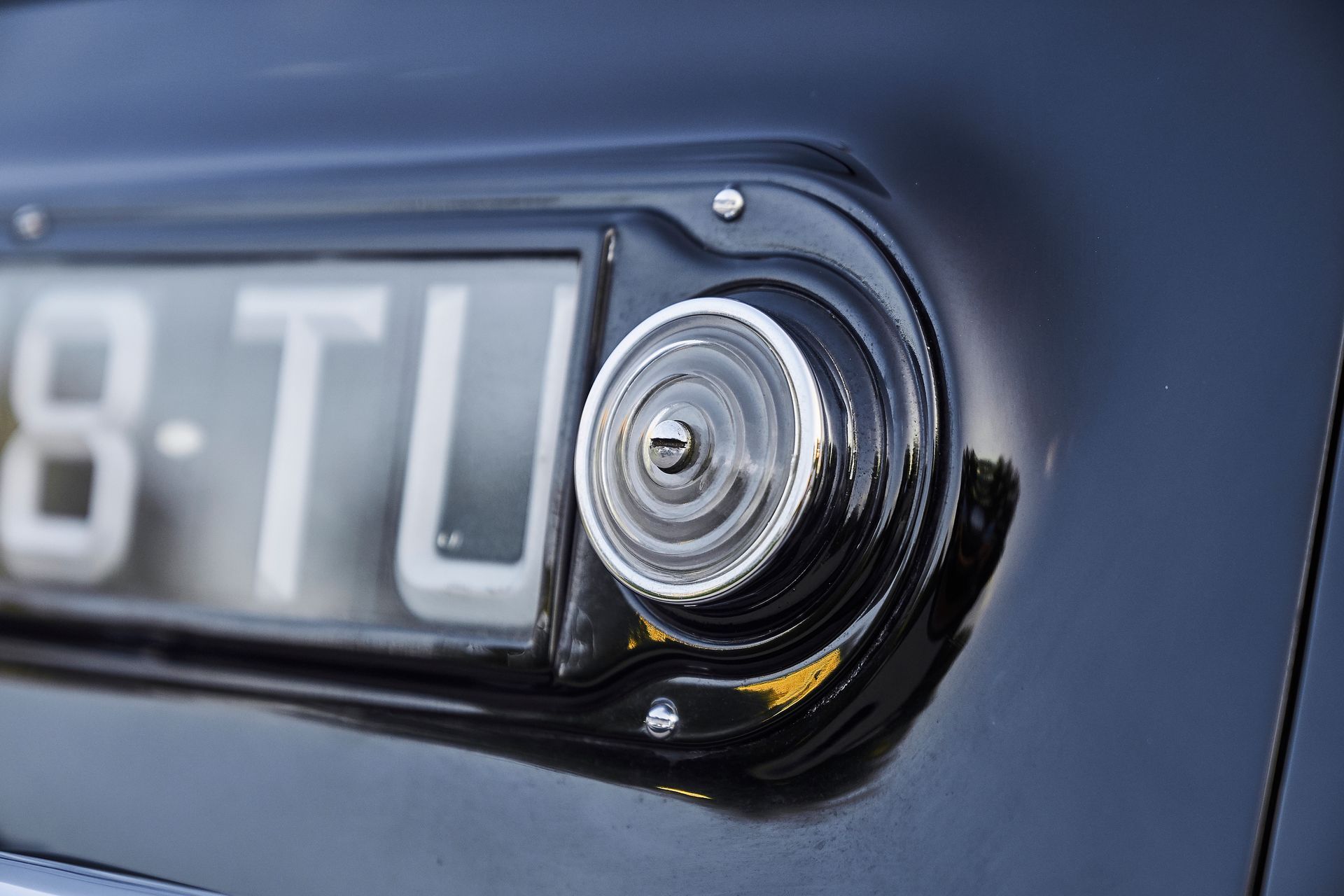 A close up of a license plate on a black car.