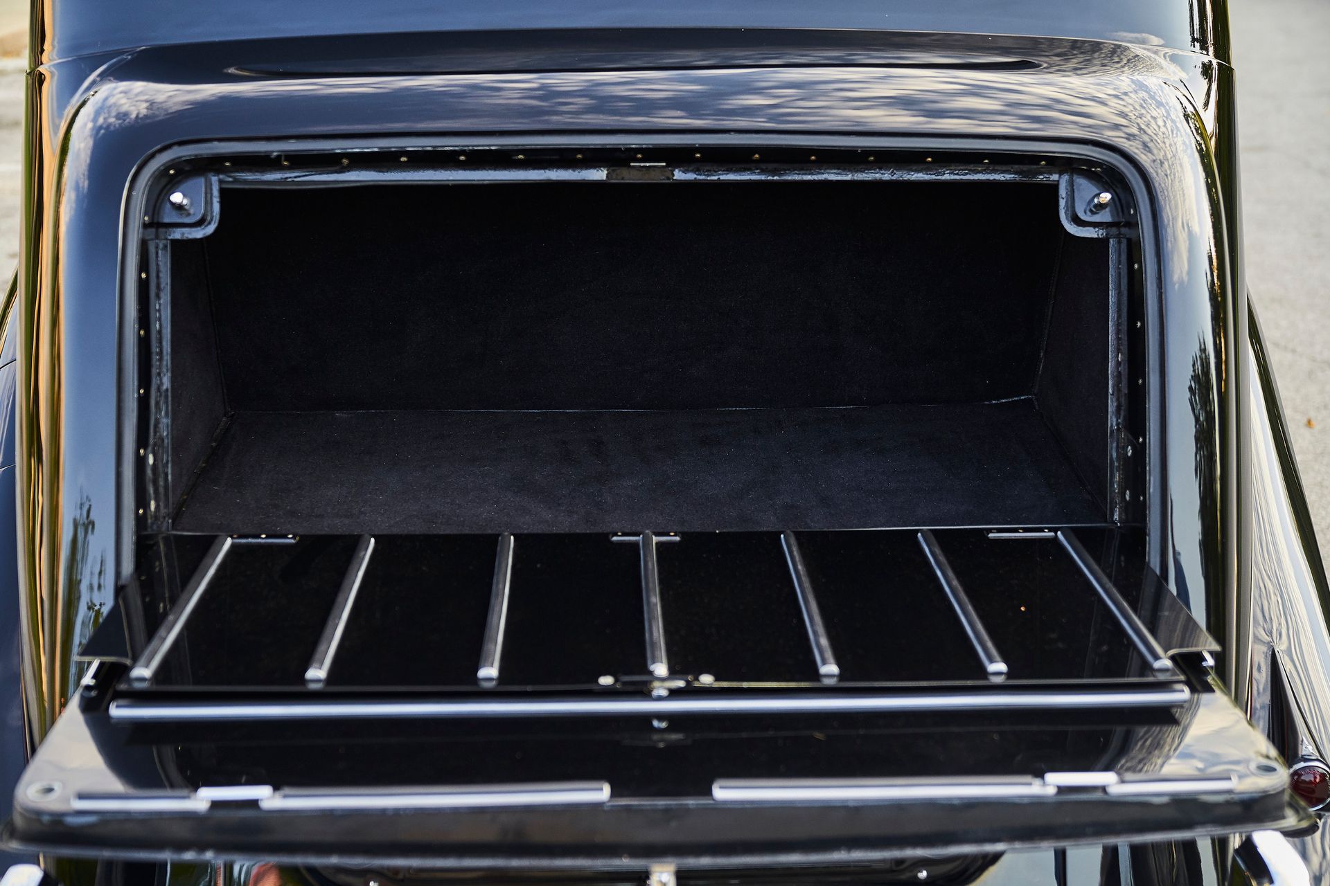The back of a black car with the trunk open