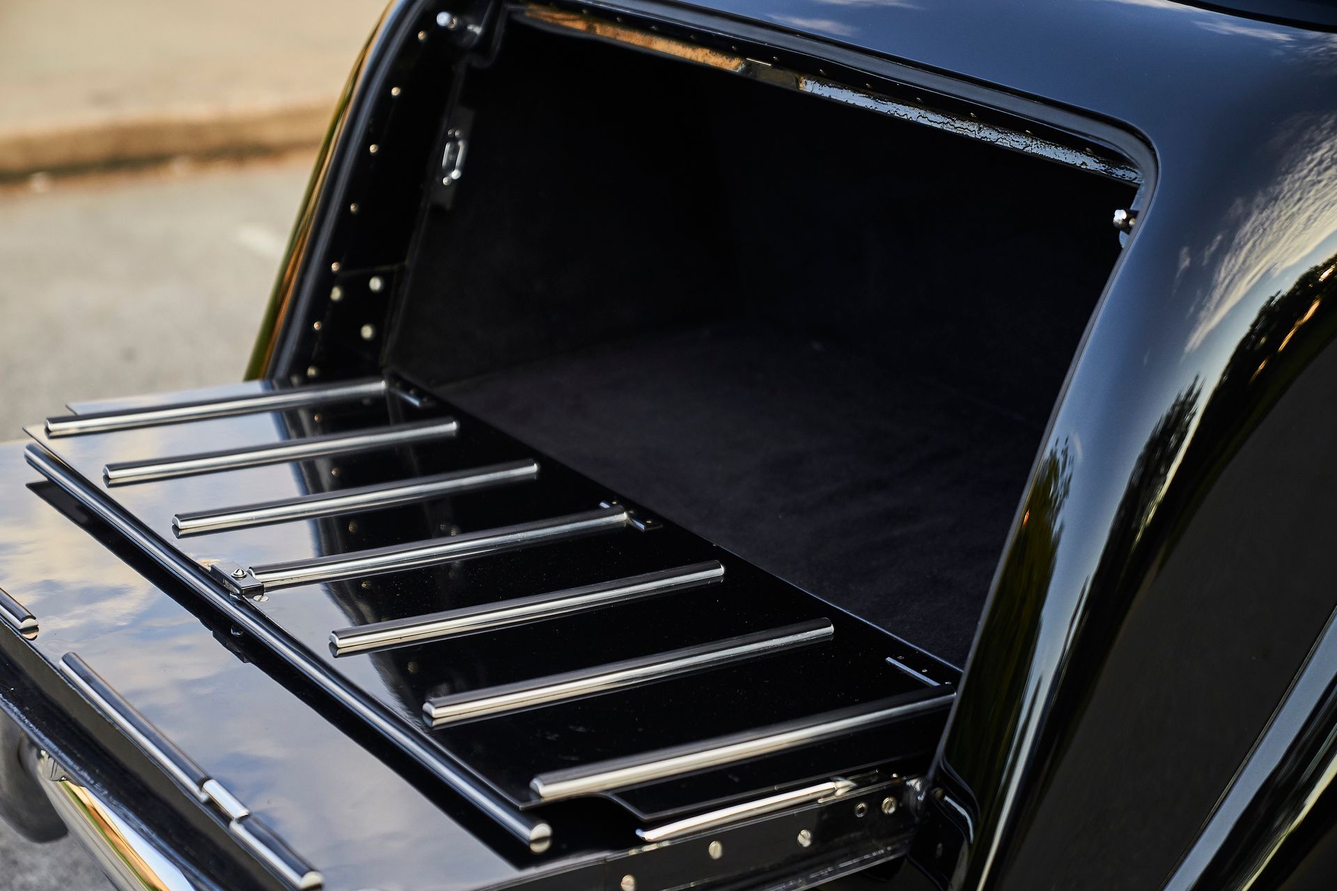 The back of a black car with the trunk open