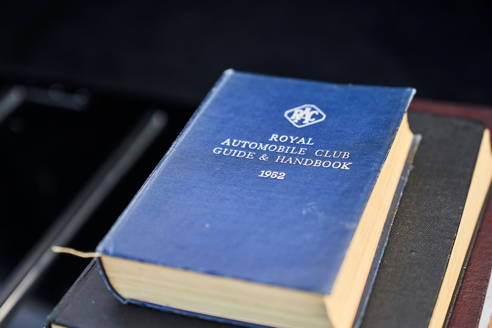 A blue book titled royal automobile club guide and handbook