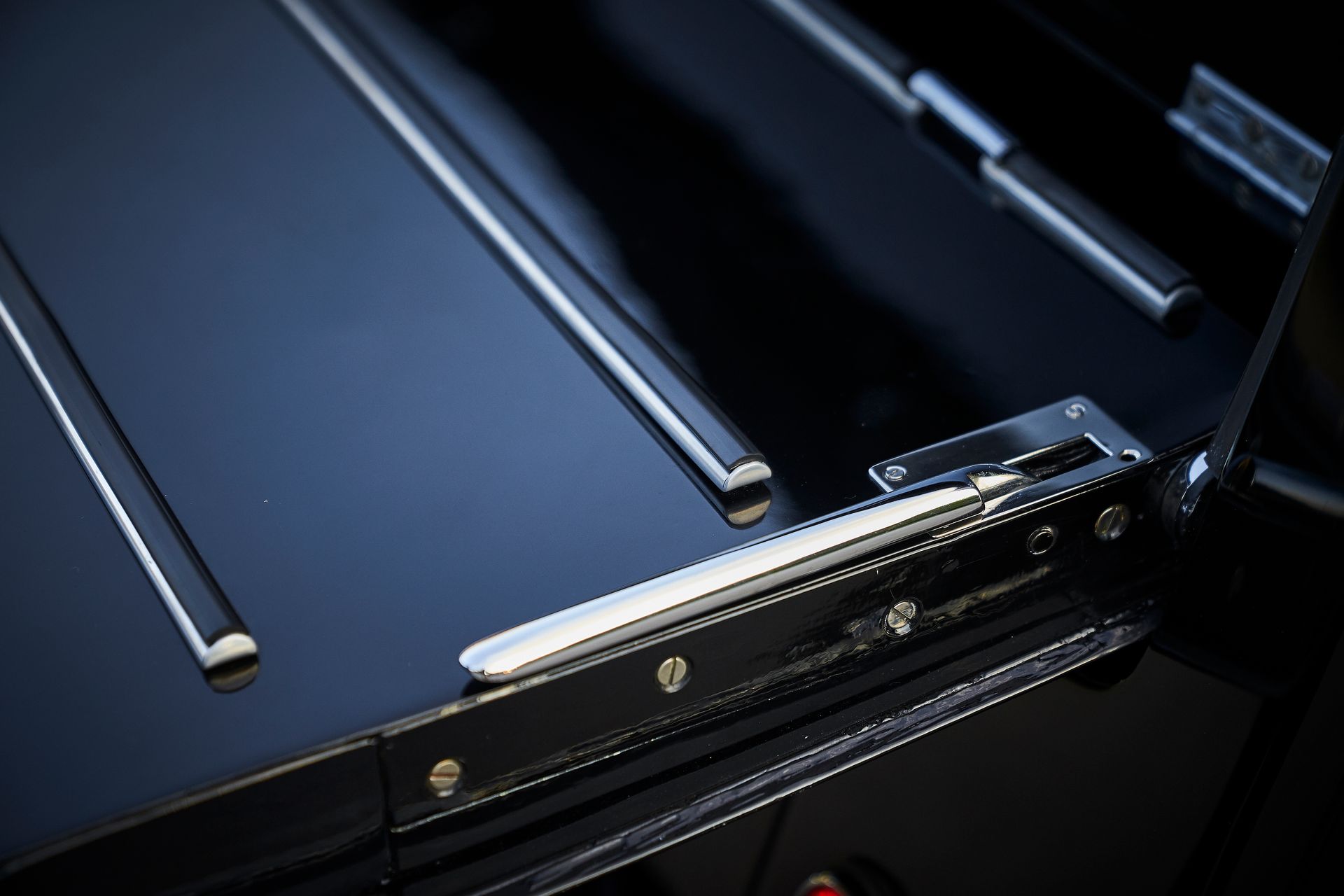 A close up of a black suitcase with a silver handle
