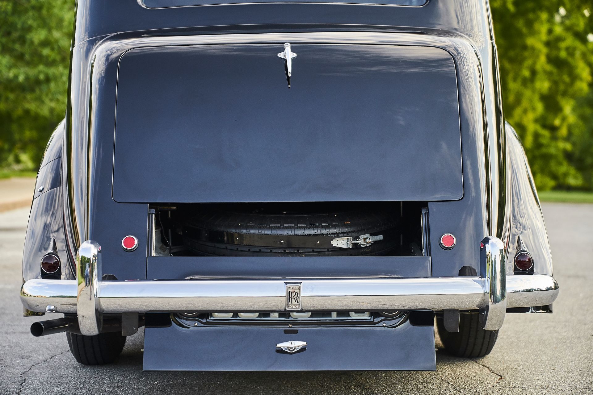 The back of a black car with a cross on it