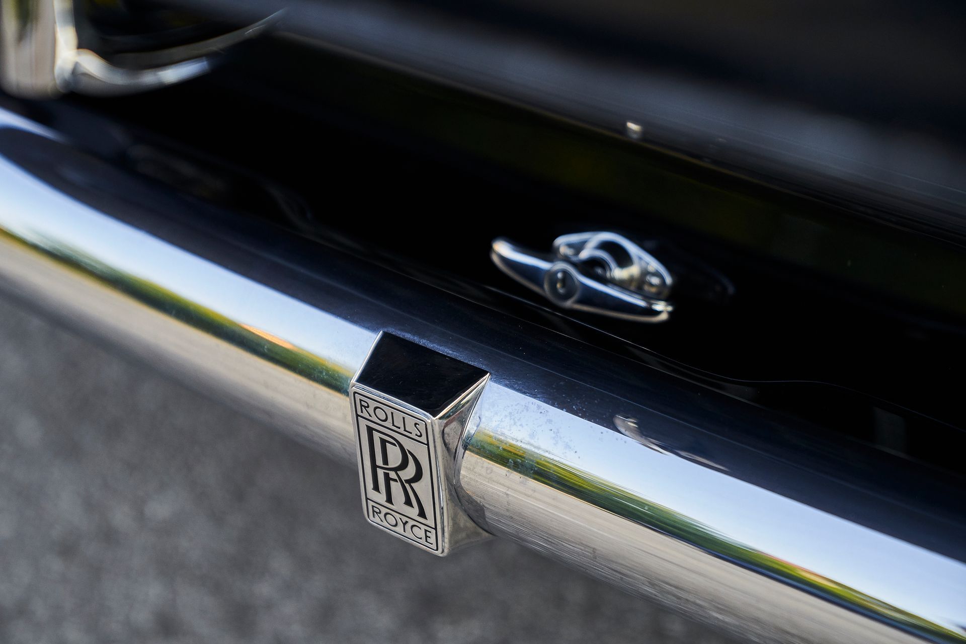 A close up of the rear bumper of a rolls royce car.