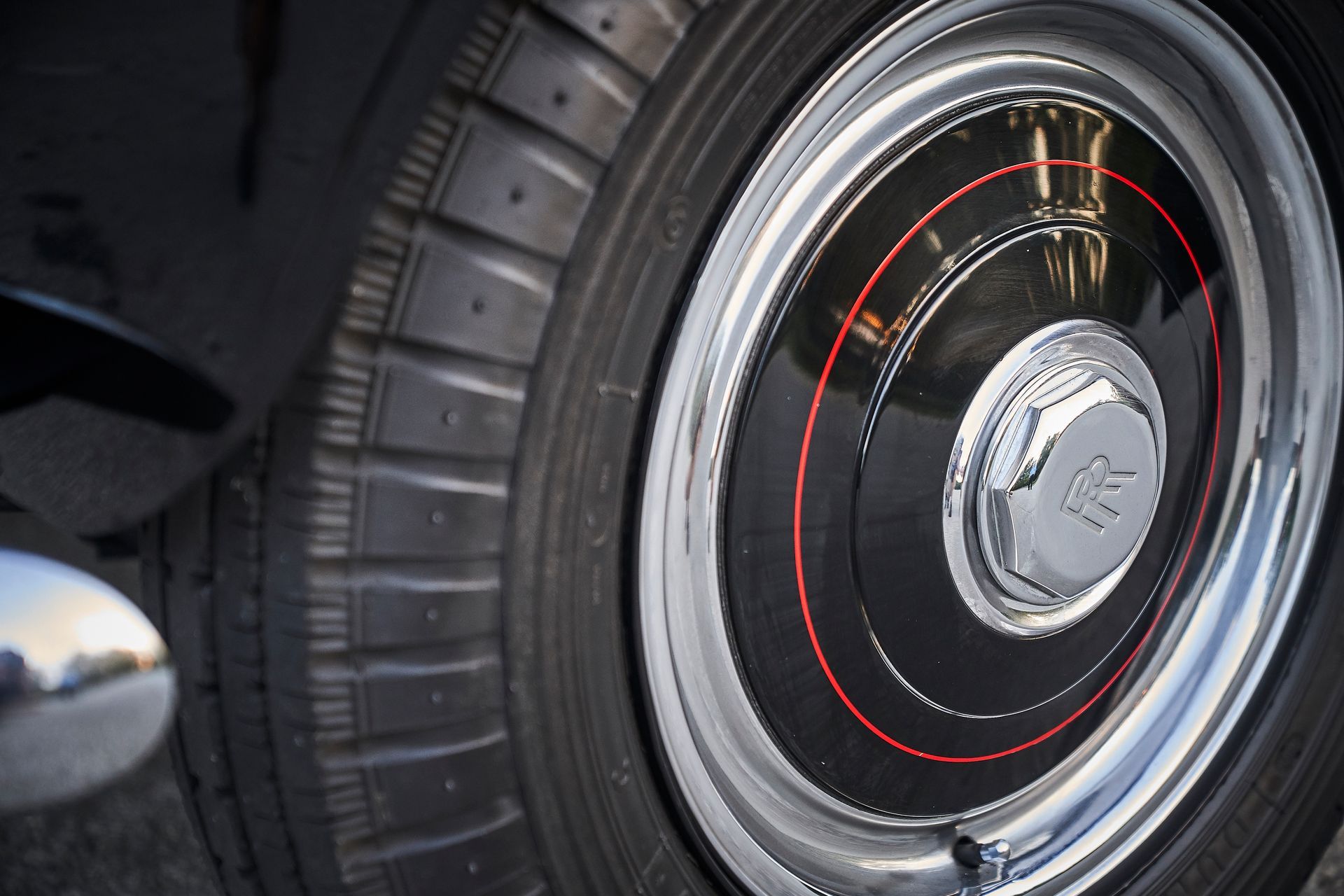 A close up of a car wheel with a tire on it
