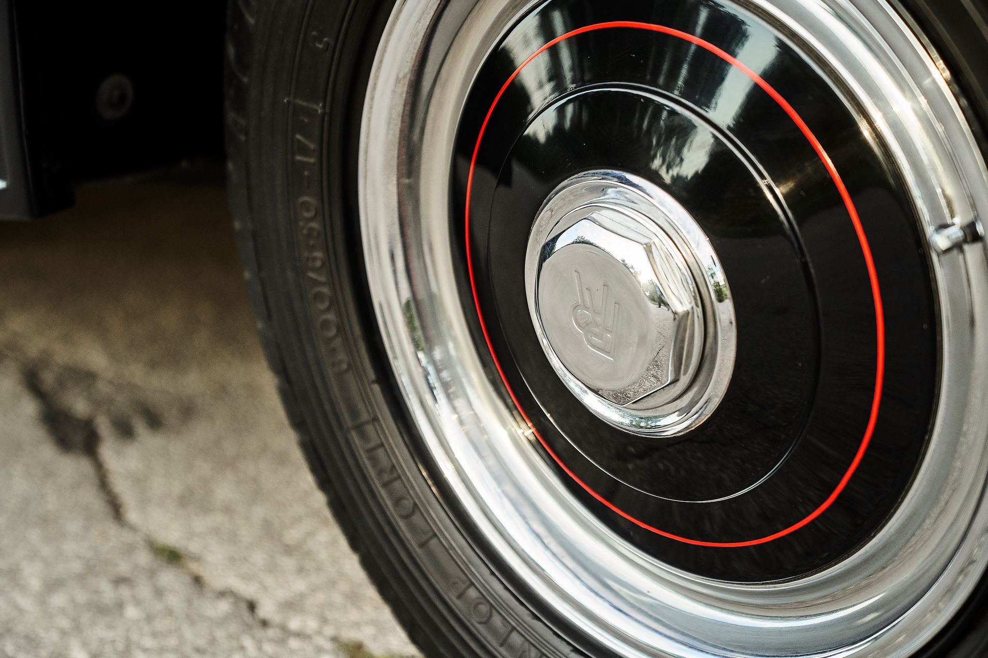 A close up of a car wheel with a red stripe on it
