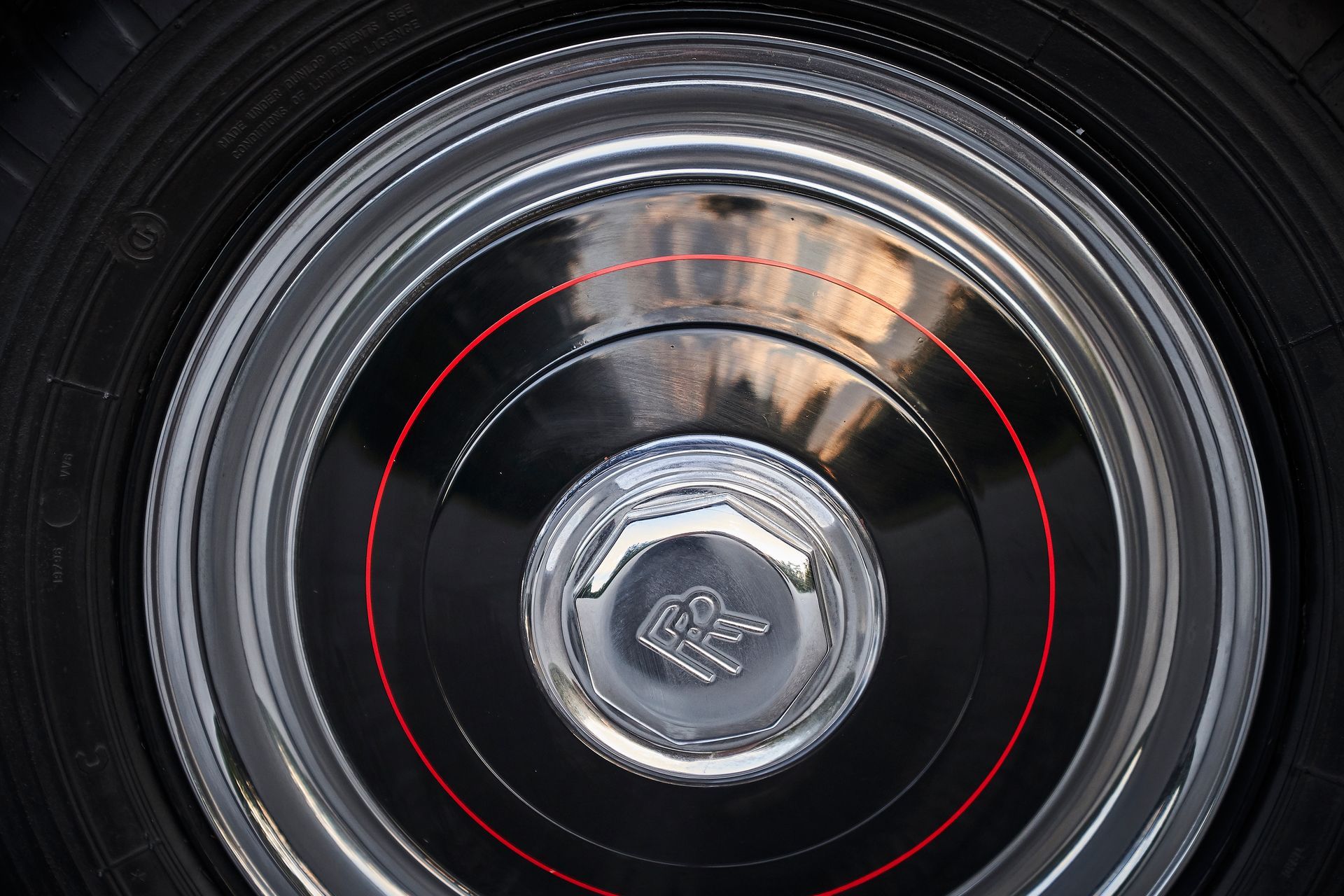 A close up of a car wheel with a red rim