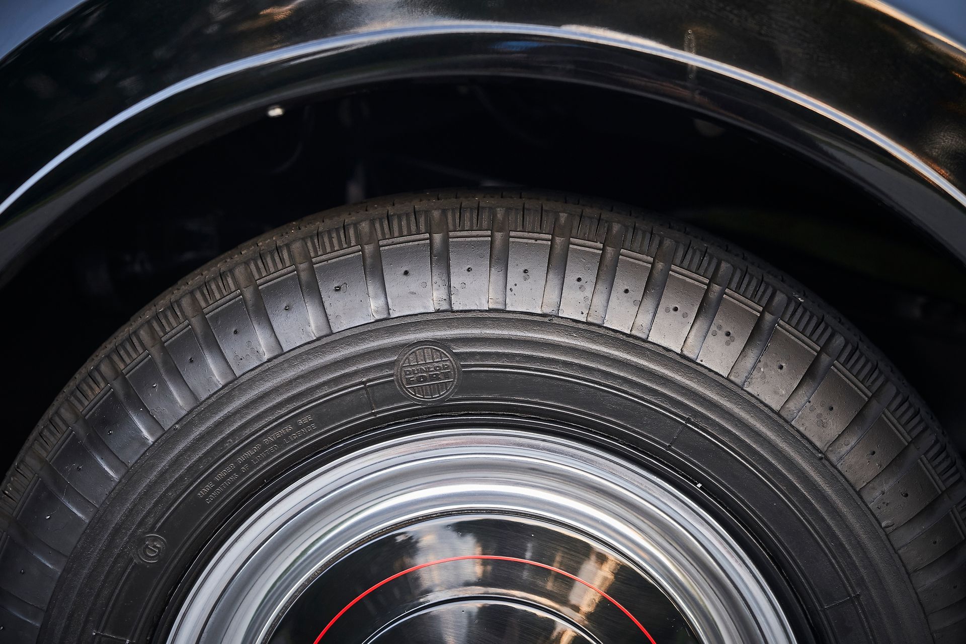 A close up of a tire on a black car