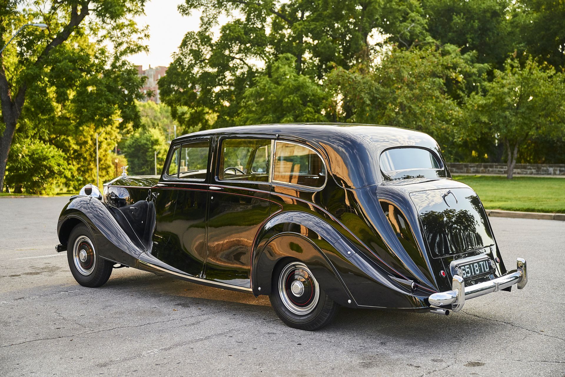 A black limousine is parked on the side of the road.