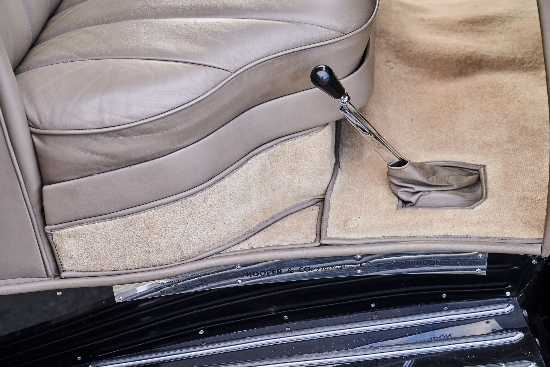 A close up of a car seat with a screwdriver in it
