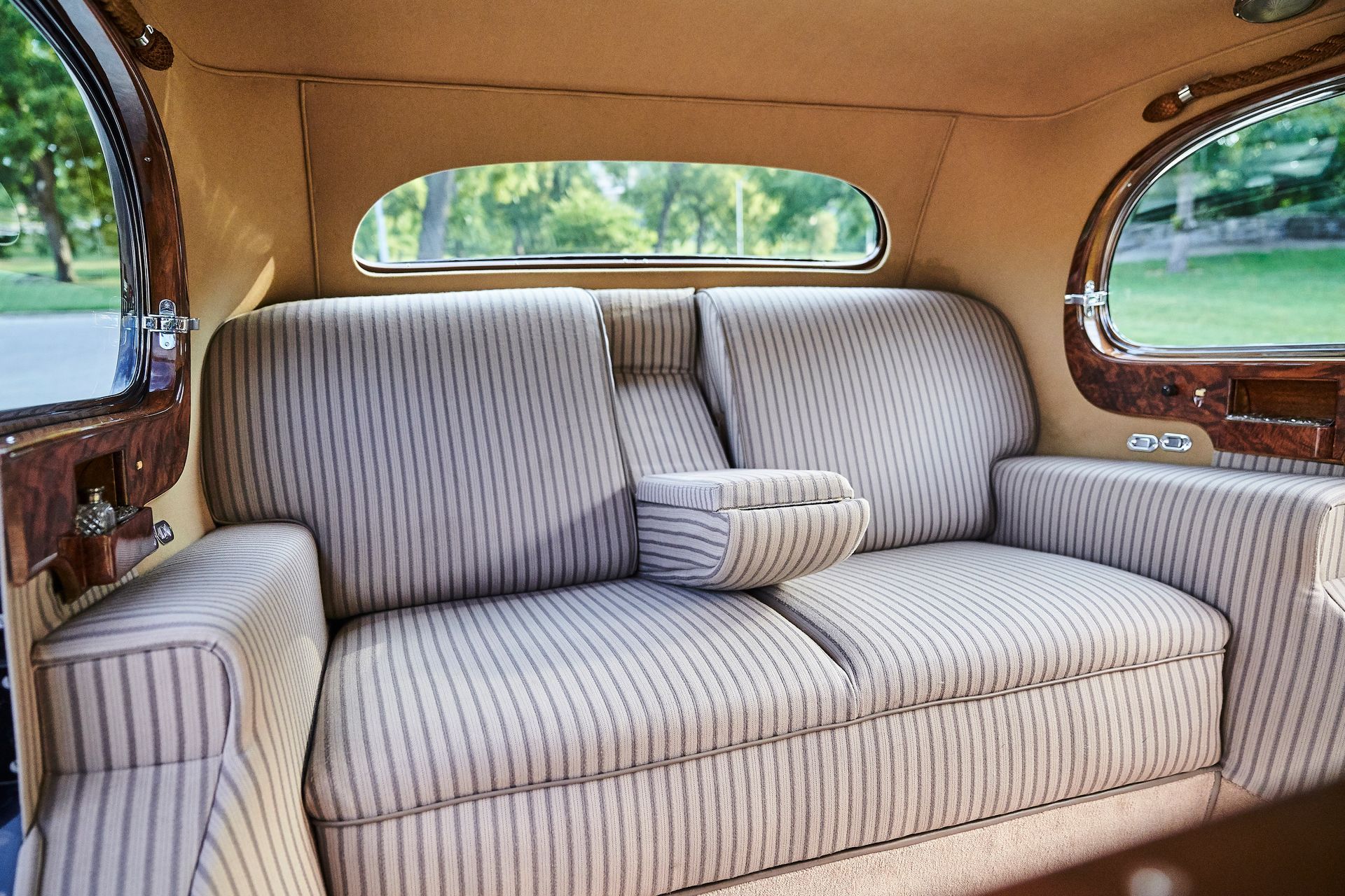 A couch is sitting in the back seat of a car.