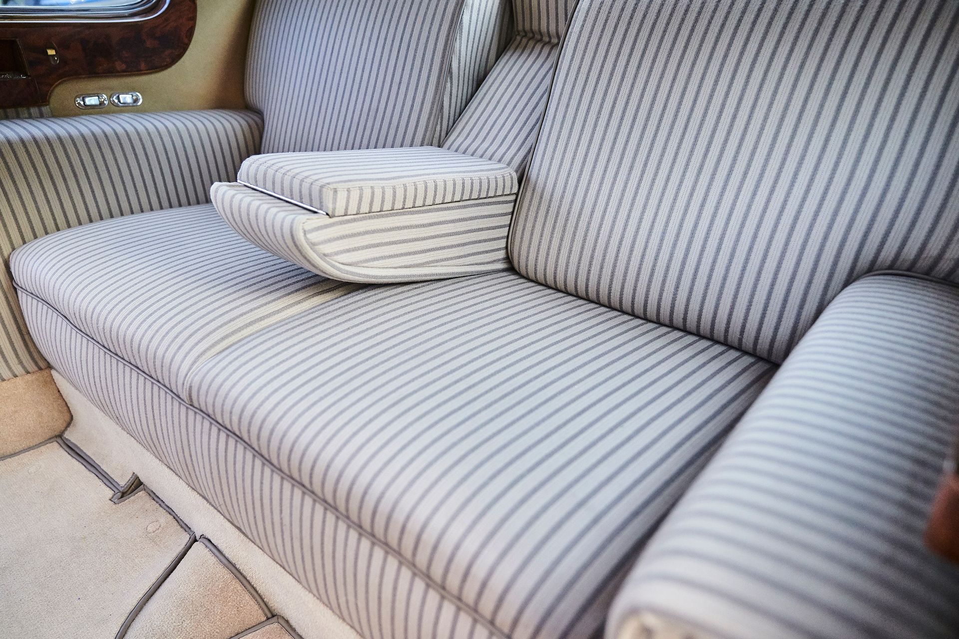 A close up of a striped couch in a car